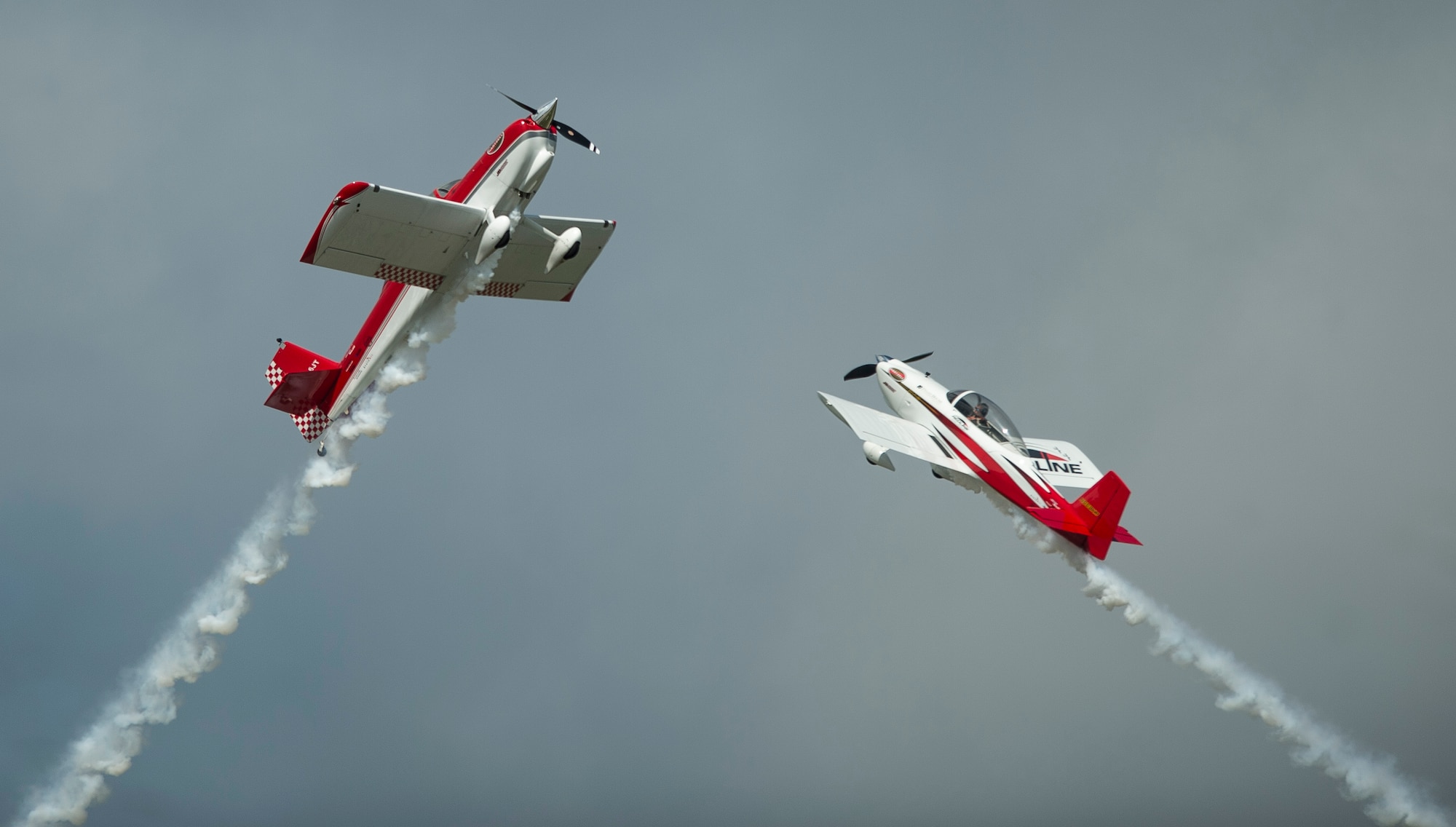 The RedLine Air Shows aerobatic performance team flies overhead during the AirPower over Hampton Roads Open House at Langley Air Force Base, Va., April 23, 2016. RedLine Airshows is a two-ship team that performs opposing, inverted and formation maneuvers. (U.S. Air Force photo by Senior Airman Kayla Newman)