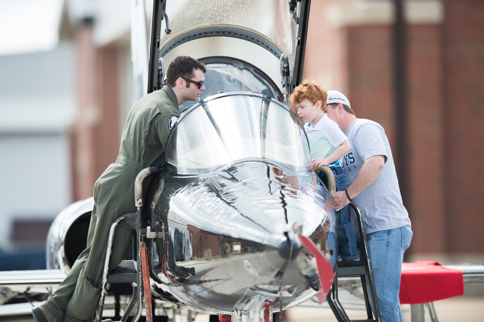 A U.S. Air Force pilot introduces a T-38 Talon to a young spectator at the AirPower over Hampton Roads Open House at Langley Air Force Base, Va., April 23, 2016. The open house gave military and civilian personnel the opportunity to get up-close-and-personal with various aircraft and witness the Air Force’s past and present airpower capabilities. (U.S. Air Force photo by Senior Airman Kayla Newman)