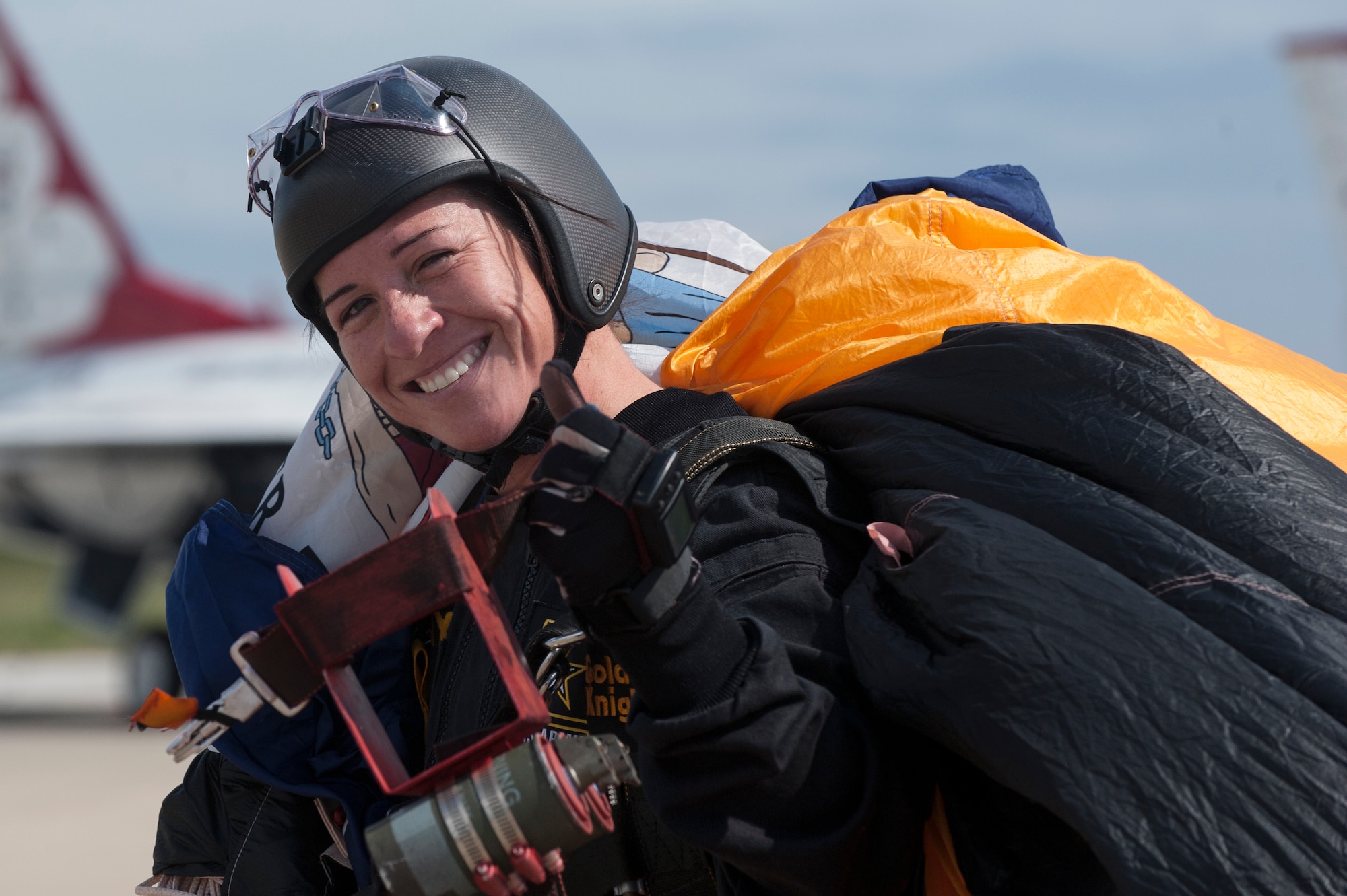 A member of the U.S. Army Golden Knights parachute team gives a thumbs up to the crowd after successfully landing a jump during the AirPower over Hampton Roads Open House at Langley Air Force Base, Va., April 23, 2016. The team is composed of approximately 95 men and women, which include four parachute units, an aviation unit and a headquarters. (U.S. Air Force photo by Airman 1st Class Kaylee Dubois)