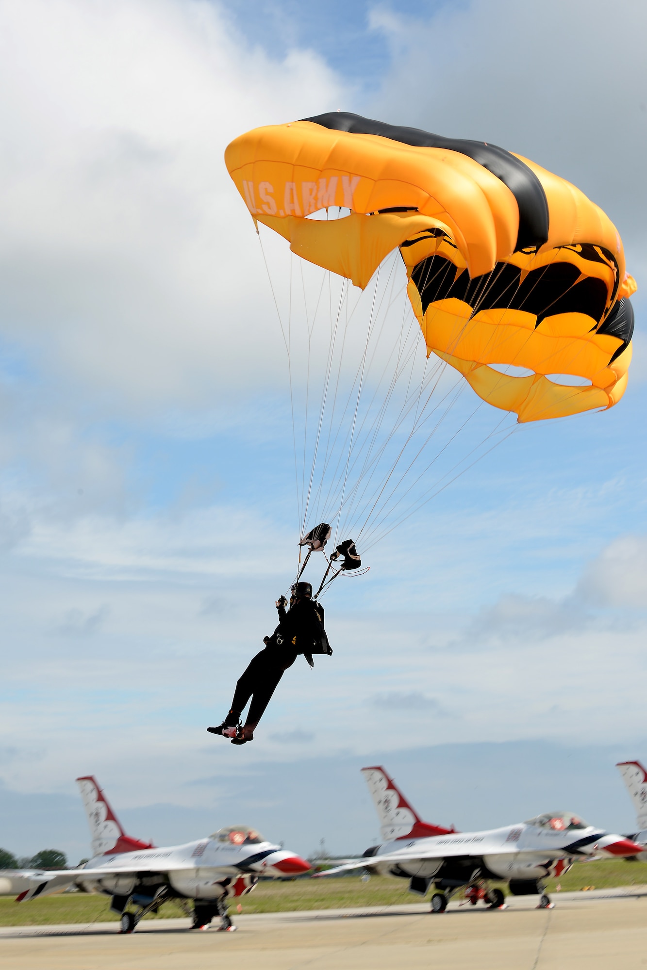 A member of the U.S. Army Golden Knights parachute team sail toward the ground during the AirPower over Hampton Roads Open House at Langley Air Force Base, Va., April 23, 2016. The Golden Knights are one of three Department of Defense-sanctioned aerial demonstration teams, along with the U.S. Navy Blue Angels and the U.S. Air Force Thunderbirds. (U.S. Air Force photo by Staff Sgt. Teresa J. Cleveland)