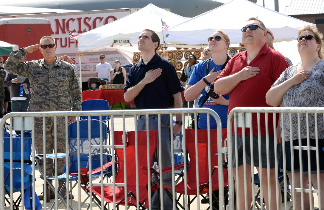 Spectators pay respect to the American Flag during the AirPower over Hampton Roads Open House at Langley Air Force Base, Va., April 23, 2016. The open house gives military and civilian personnel the opportunity to get up-close-and-personal with various aircraft and witness the Air Force’s past and present capabilities in airpower. (U.S. Air Force photo by Staff Sgt. Teresa J. Cleveland)