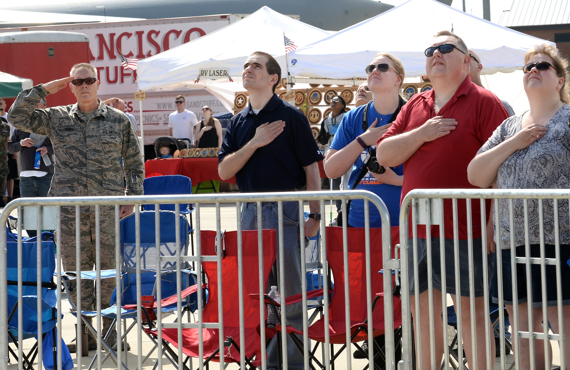 Spectators pay respect to the American Flag during the AirPower over Hampton Roads Open House at Langley Air Force Base, Va., April 23, 2016. The open house gives military and civilian personnel the opportunity to get up-close-and-personal with various aircraft and witness the Air Force’s past and present capabilities in airpower. (U.S. Air Force photo by Staff Sgt. Teresa J. Cleveland)