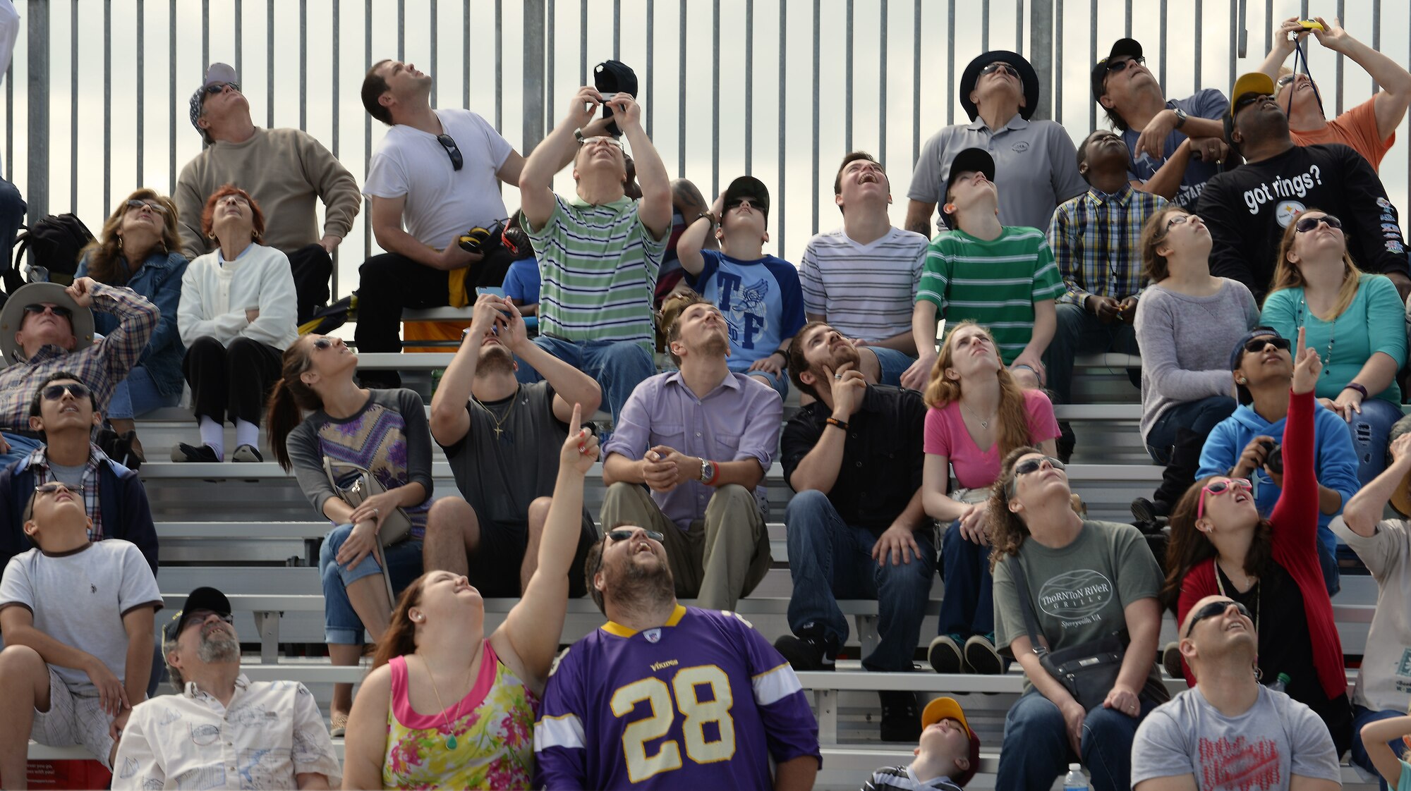Spectators watch an aerial performance at the AirPower over Hampton Roads Open House at Langley Air Force Base, Va., April 23, 2016. The open house provided an avenue in which the public could see modern and historical military aircraft in action. (U.S. Air Force photo by Staff Sgt. Teresa J. Cleveland)