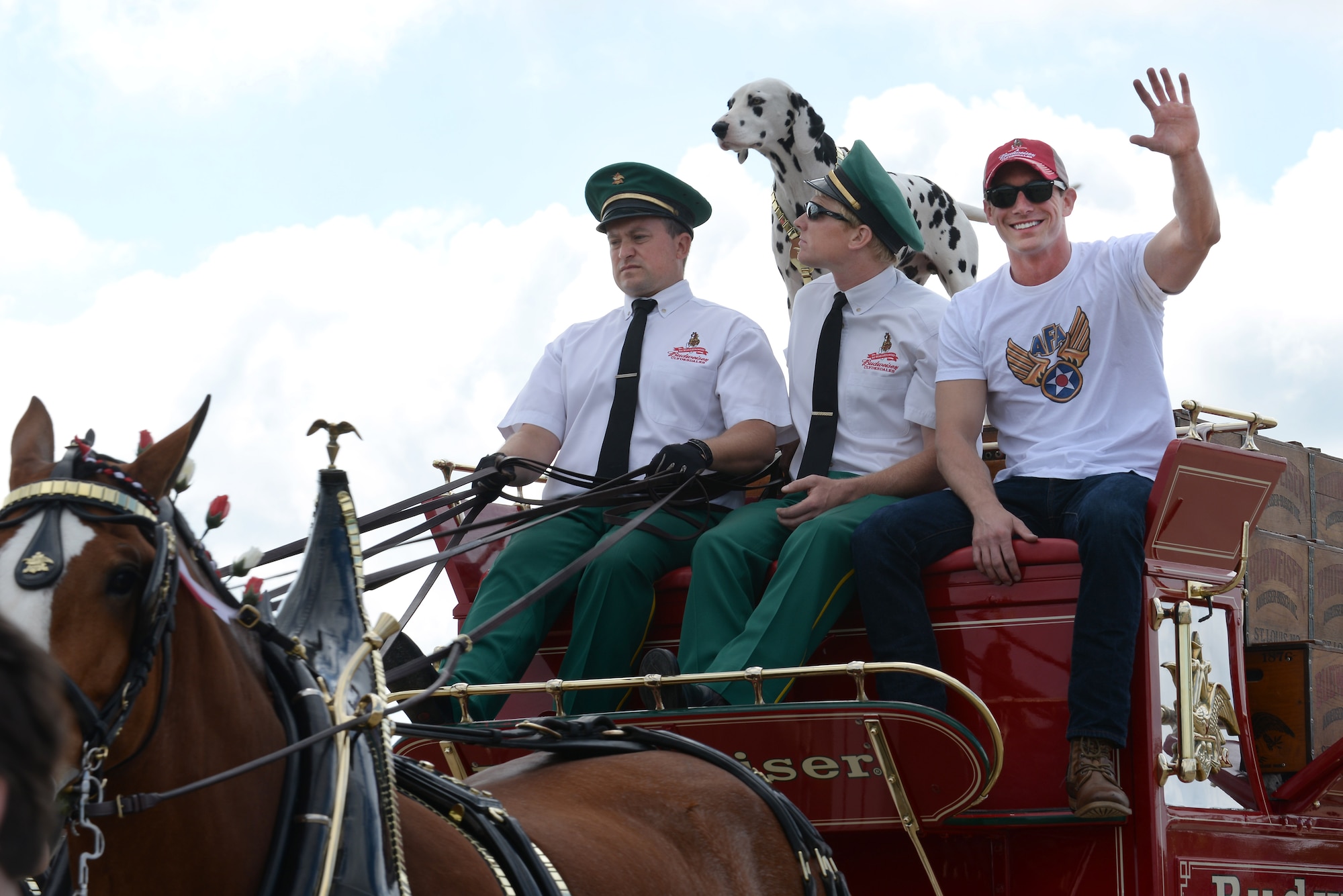 Tyler Johnson, president of the Langley Chapter Air Force Association, rides on the Budweiser Clydesdales wagon during the AirPower over Hampton Roads Open House at Langley Air Force Base, Va., April 23, 2016. The first open house at Langley Air Force Base was held in 1919 and was called an aerial circus. (U.S. Air Force photo by Staff Sgt. Teresa J. Cleveland)