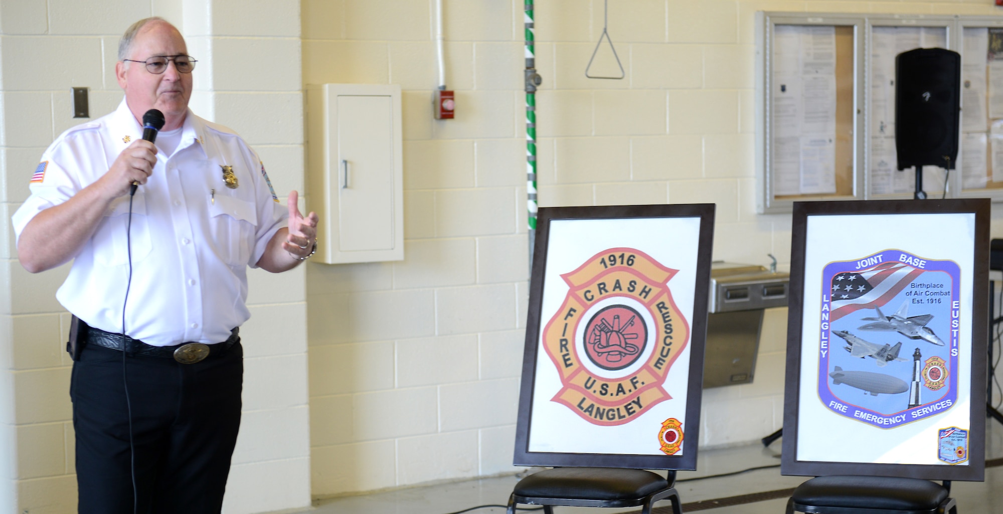 Wayne Mello, Langley Air Force Base fire chief, retires the fire department’s 1975 patch and unveils the new patch during a ceremony before the AirPower over Hampton Roads Open House at Langley Air Force Base, Va., April 23, 2016. The ceremony commemorated the department’s centennial. (U.S. Air Force photo by Staff Sgt. Teresa J. Cleveland)