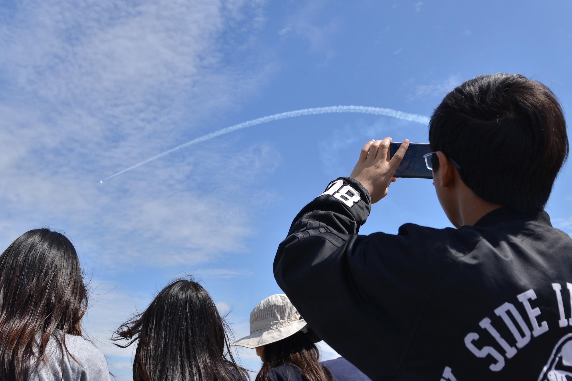 AirPower over Hamptons Roads Open House spectators film a show performance at Langley Air Force Base, Va., April 23, 2016. The open house aims to educate the public on past and present Air Force aerial capabilities, increase recruiting and show appreciation to the local community. (U.S. Air Force photo by Staff Sgt. Natasha Stannard)