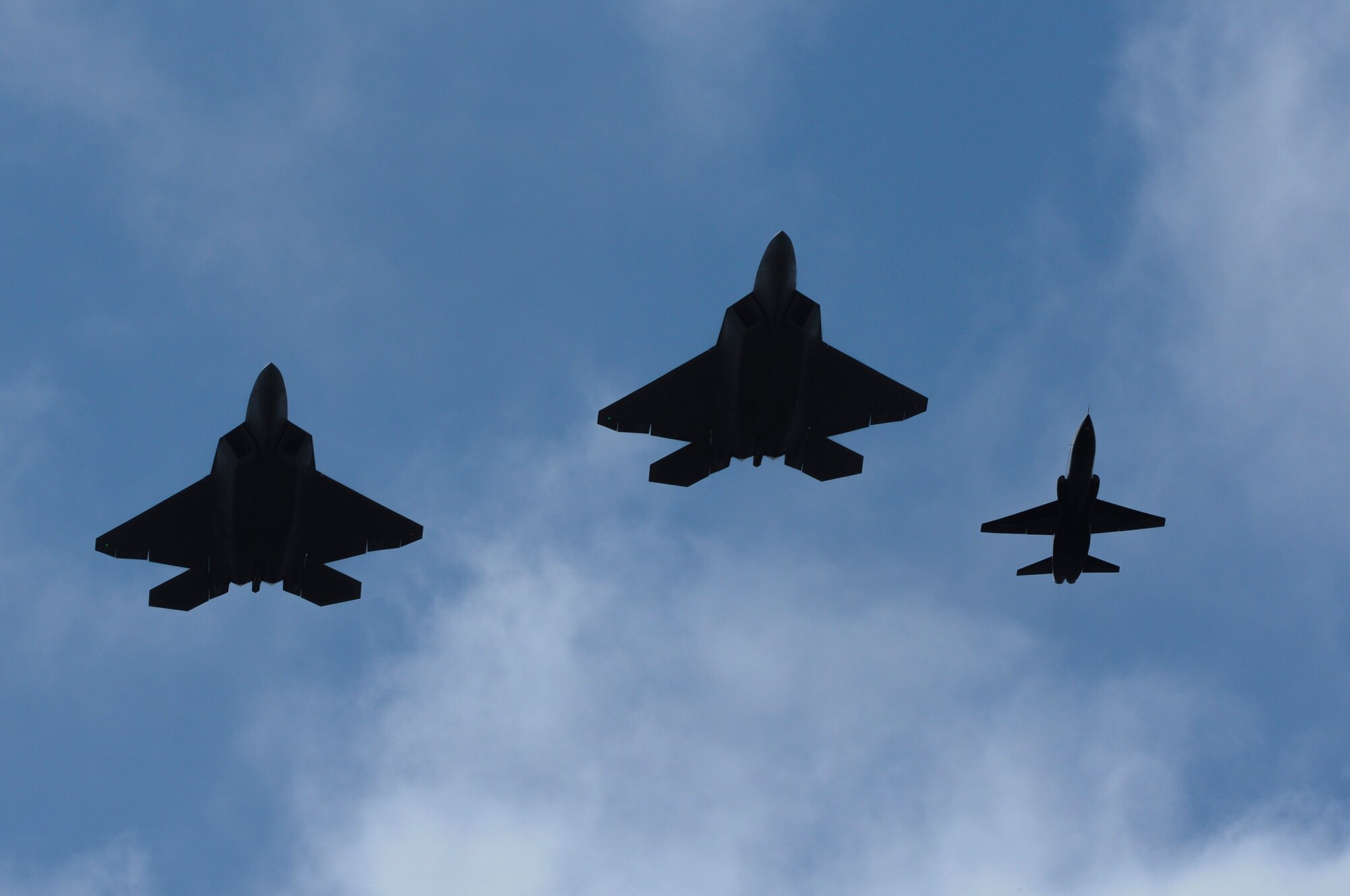 Two U.S. Air Force F-22 Raptors and a T-38 Talon fly in formation during the AirPower over Hampton Roads Open House at Langley Air Force Base, Va., April 23, 2016. This air show marks the first of its kind at the base in five years. (U.S. Air Force photo by Staff Sgt. Natasha Stannard)