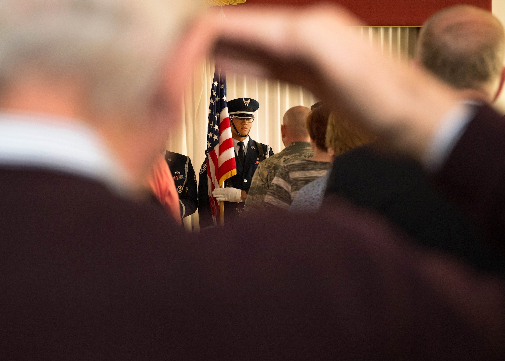 A member of the Patriot Honor Guard team presents the colors during the Military Retiree Day event at the Minuteman Commons, April 22. The event kicked off with an Information Services session that provided retirees an opportunity to browse information tables staffed by representatives of both on- and off-base agencies and organizations. Massachusetts Secretary of Veterans' Affairs Francisco Urena was the keynote speaker during a luncheon to close out the event. (U.S. Air Force photo by Jerry Saslav)
