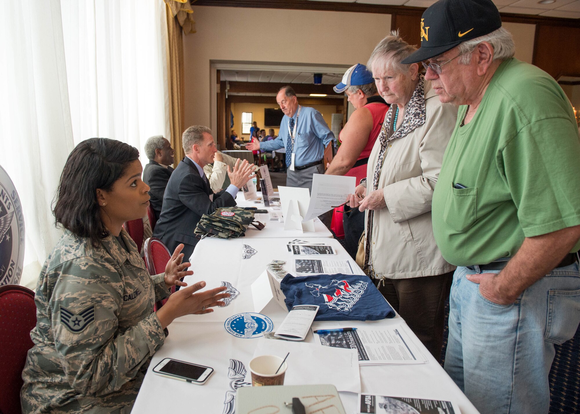 Staff Sgt. Tiffany Caldwell, a member of the local Air Force Sergeants Association, speaks with retirees during the Military Retiree Day event at the Minuteman Commons, April 22. The event kicked off with an Information Services session that provided retirees an opportunity to browse information tables staffed by representatives of both on- and off-base agencies and organizations. Massachusetts Secretary of Veterans' Affairs Francisco Urena was the keynote speaker during a luncheon to close out the event. (U.S. Air Force photo by Jerry Saslav)