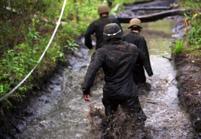 Marines with Combat Logistics Regiment 2, make their way through an endurance course at Camp Lejeune, N.C., April 22, 2016. The unit pushed through the grueling 3.4 mile course to improve their ability to work as a team and to build camaraderie.