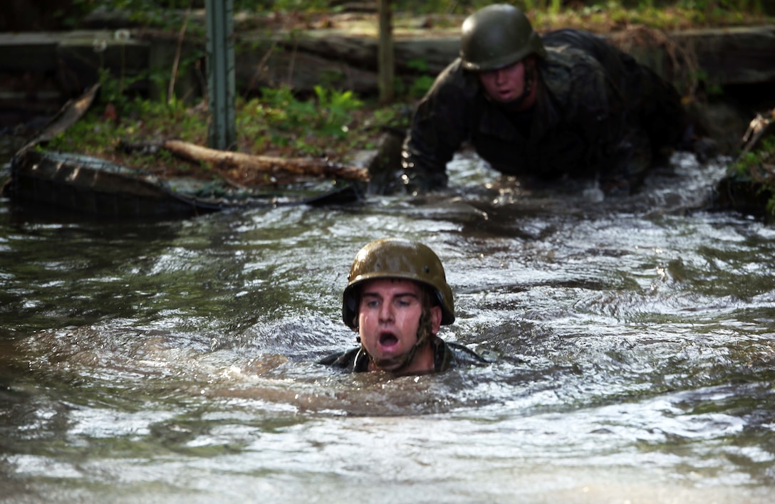 Gunnery Sgt. Joseph Janez, a career planner with Combat Logistics Regiment 2, swims through one of the deeper mud puddles during the endurance course at Camp Lejeune, N.C., April 22, 2016. The unit pushed through the grueling 3.4 mile course to improve their ability to work as a team and to build camaraderie.