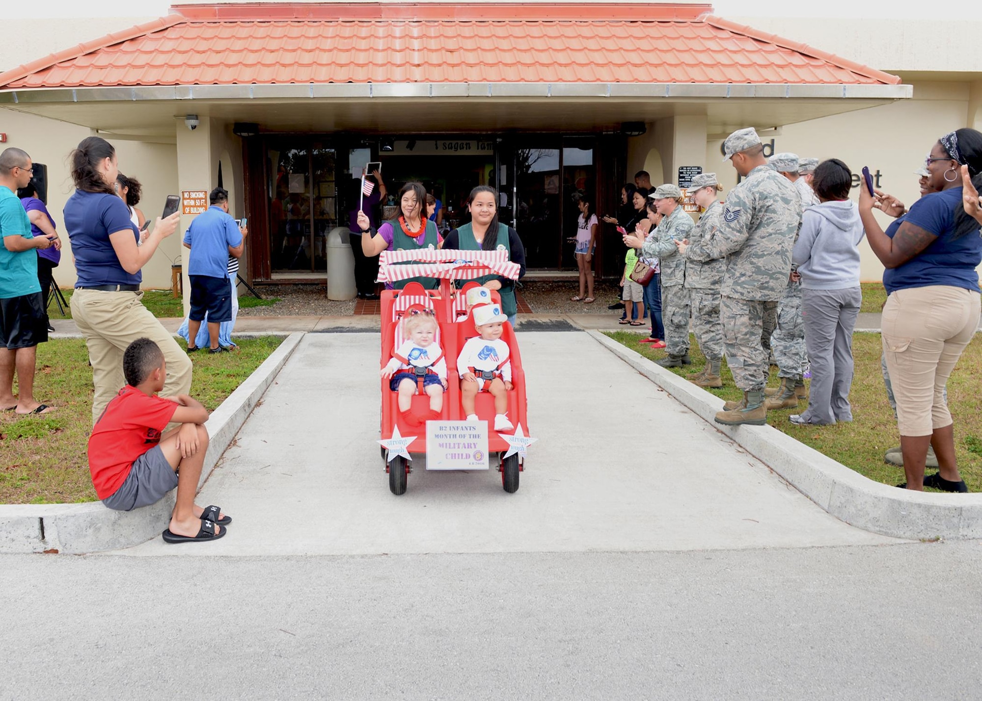 Parents rally at the Andersen Child Development Center to celebrate the Month of the Military Child April 8, 2016, at Andersen Air Force Base, Guam. April is designated as the Month of the Military Child to recognize the sacrifices and contributions of children in the armed forces community. (U.S. Air Force photo by Senior Airman Cierra Presentado/Released)