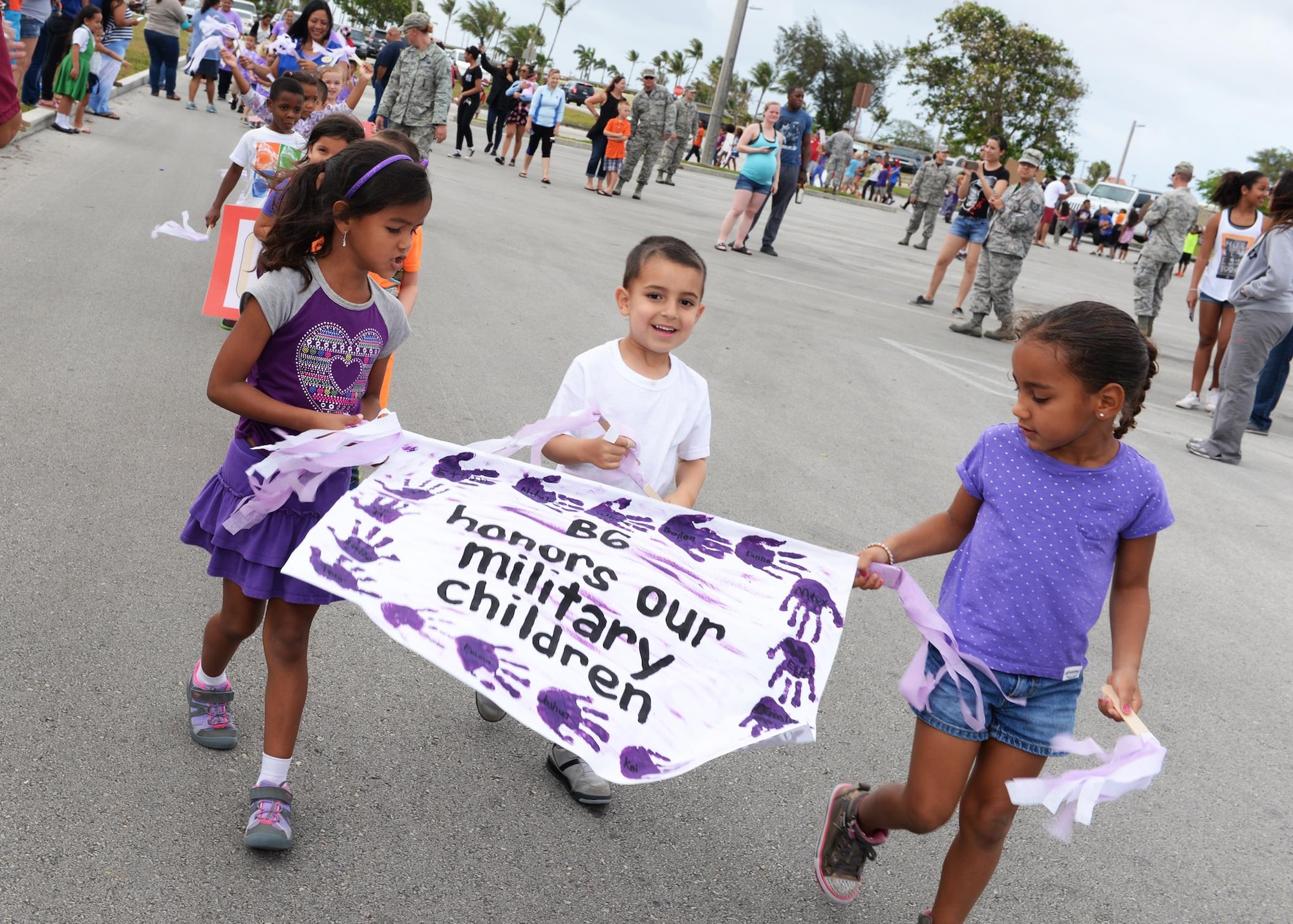 Children walk in a parade to celebrate the Month of the Military Child April 8, 2016, at Andersen Air Force Base, Guam. In 1986, April was designated to recognize the sacrifices and contributions of children of members of the armed forces. (U.S. Air Force photo by Senior Airman Cierra Presentado/Released)