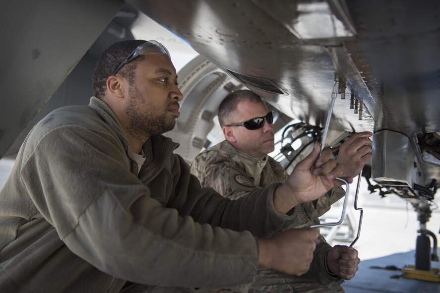 Staff Sgt. Dante Sewell (left) and Tech. Sgt. Kevin Conklin, 455th Expeditionary Aircraft Maintenance Squadron electrical and environmental systems technicians, replace a panel after performing bleed air maintenance on an F-16 Fighting Falcon from the 421st Expeditionary Fighter Squadron at Bagram Airfield, Afghanistan, April 23, 2016. The squadron provides combat-ready aircraft to the air component commander in support of coalition forces throughout Afghanistan. (U.S. Air Force photo/Tech. Sgt. Robert Cloys)