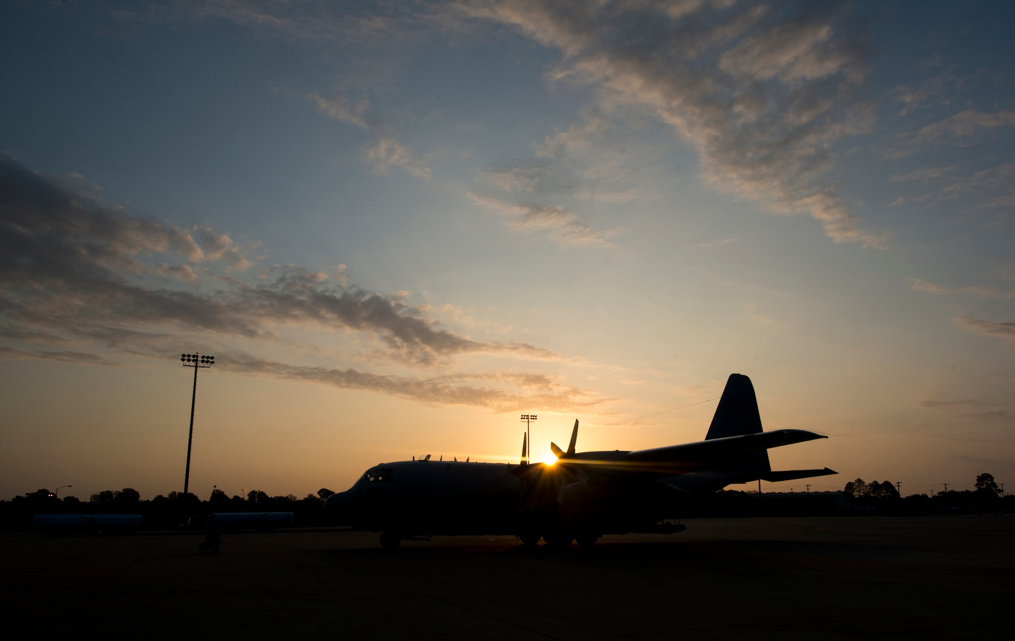 A C-130 Hercules sits on the ramp at sunrise during a Joint Readiness Training exercise at Alexandria International Airport, La. April 17, 2016. JRTC is a multinational exercise focused on pre-deployment and airdrop capabilities. (U.S. Air Force photo by Senior Airman Joshua King)