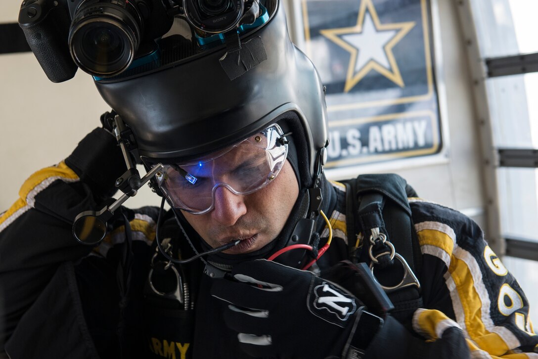 U.S. Army Staff Sgt. David Echeverry, parachutist for the Army Golden Knights, performs final checks on equipment before his jump at Langley Air Force Base, Va., April 24, 2016. The demonstration teams perform two shows from an altitude of 12,500 feet. (U.S. Air Force photo by Airman 1st Class Derek Seifert)