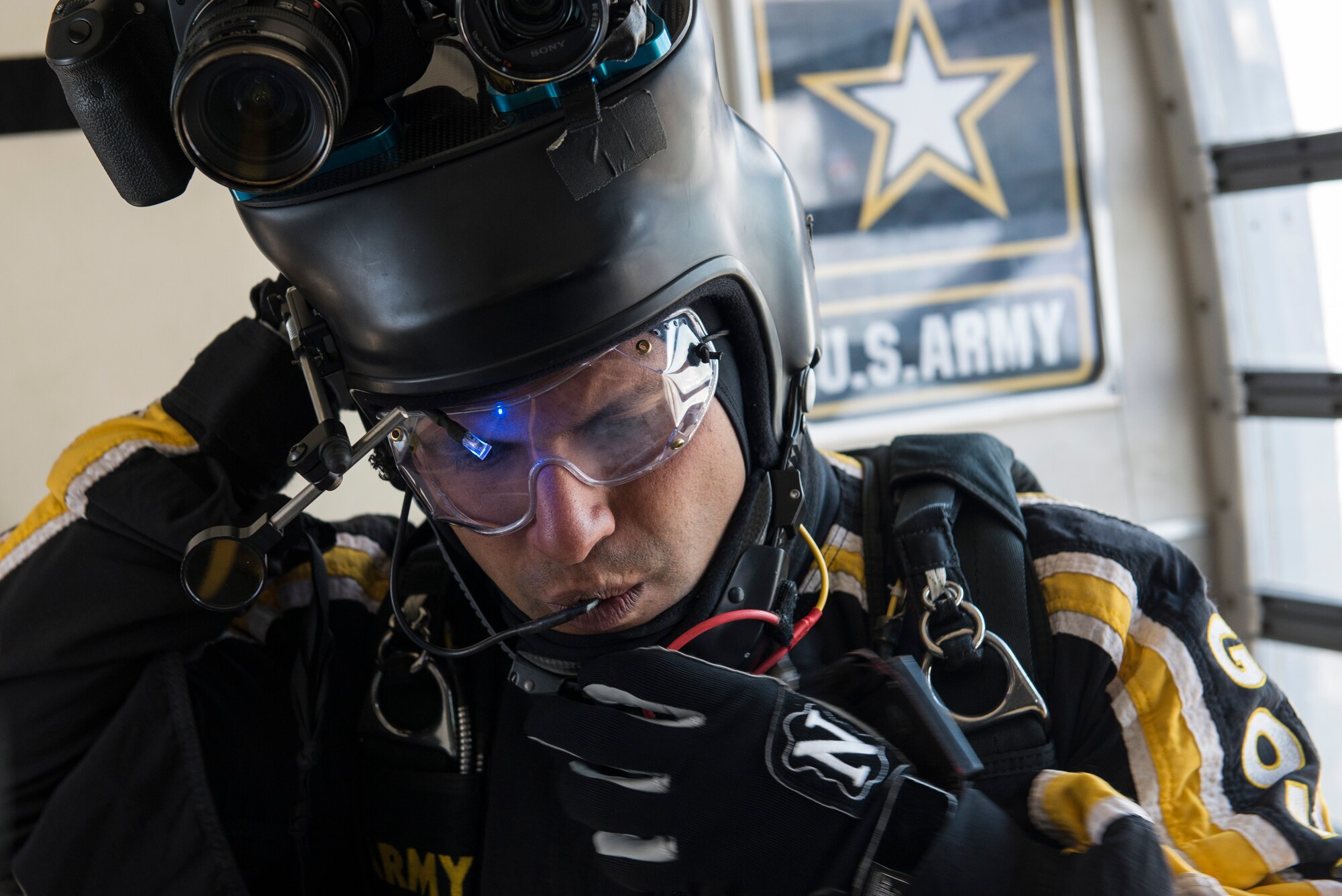 U.S. Army Staff Sgt. David Echeverry, parachutist for the Army Golden Knights, performs final checks on equipment before his jump at Langley Air Force Base, Va., April 24, 2016. The demonstration teams perform two shows from an altitude of 12,500 feet. (U.S. Air Force photo by Airman 1st Class Derek Seifert)
