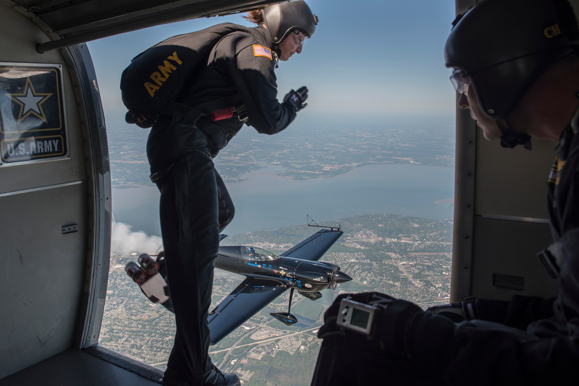 U.S. Army Sgt. 1st Class Jennifer Espinoza, parachutist for the Army Golden Knights, salutes an aircraft as she begins to parachute down onto Langley Air Force Base, Va., April 24, 2016. The demonstration teams, which use five dedicated aircraft, perform at more than 100 events per year. (U.S. Air Force photo by Airman 1st Class Derek Seifert)
