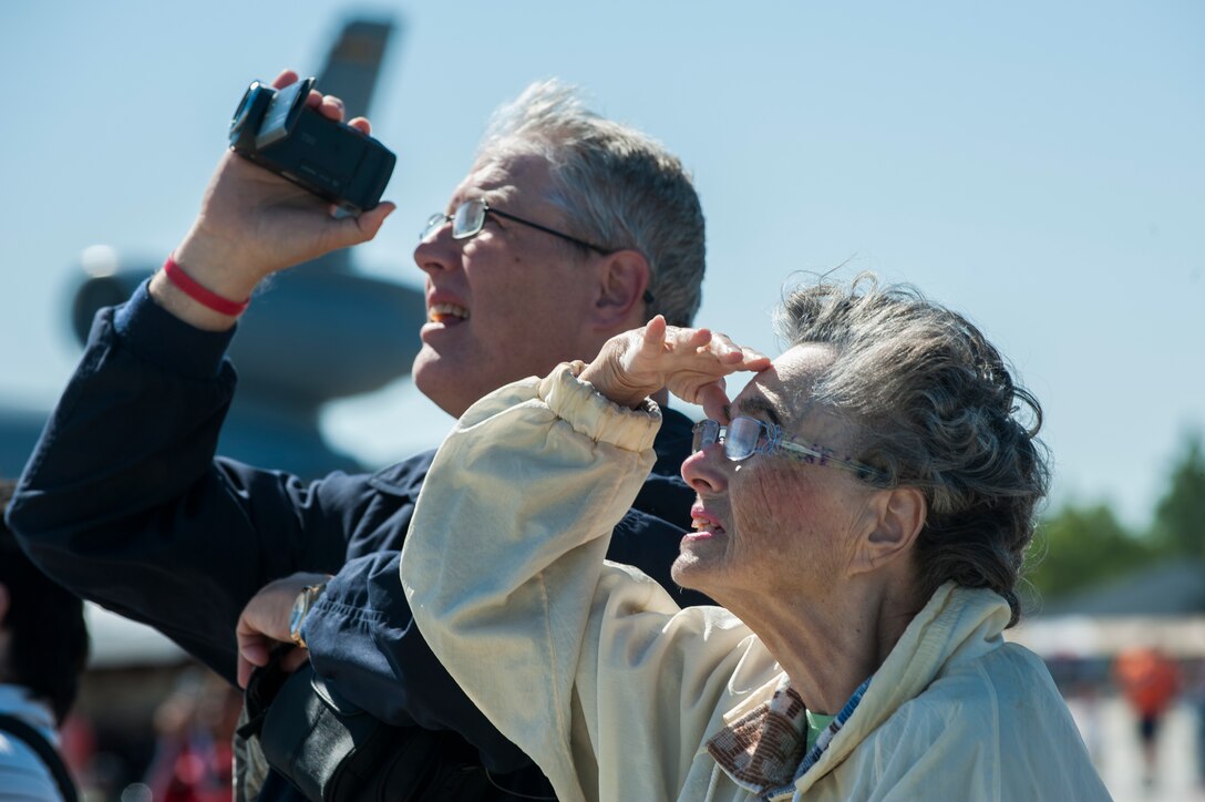 Spectators watch as the Golden Knights parachute team perform during the AirPower over Hampton Roads Open House at Langley Air Force Base, Va., April 24, 2016. The team presented the American flag as the show’s grand opening. (U.S. Air Force photo by Airman 1st Class Kaylee Dubois)