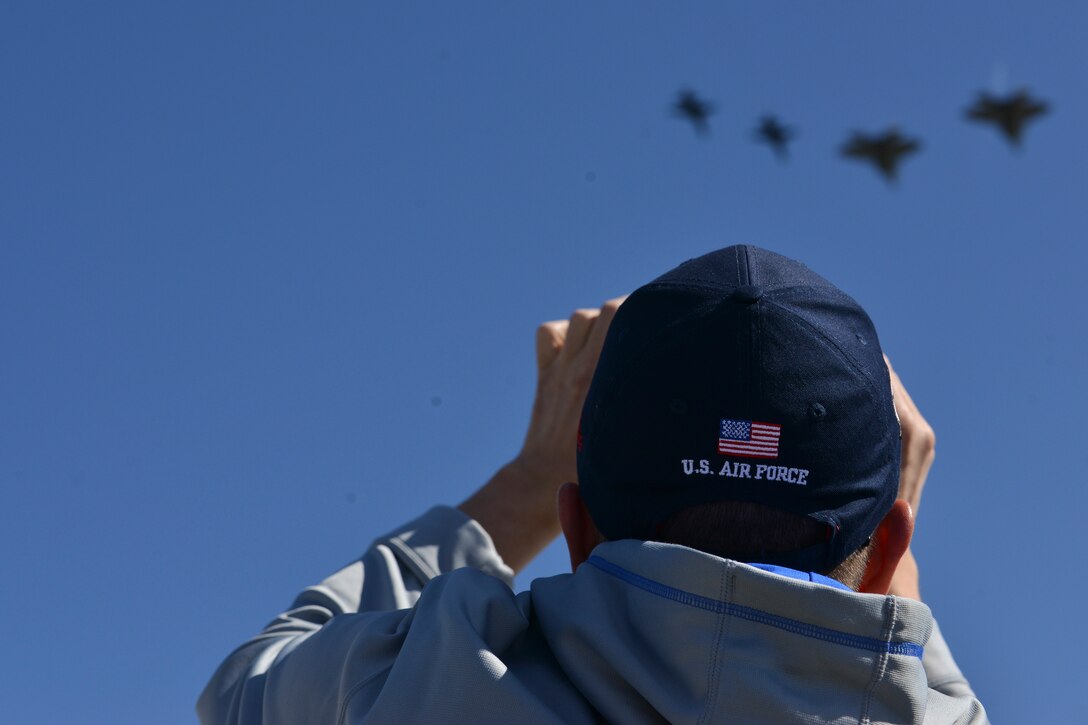 An AirPower over Hampton Roads Open House spectator photographs a fly-by at Langley Air Force Base, Va., April 24, 2016. The fly-by consisted of U.S. Air Force F-22 Raptors and T-38 Talons. (U.S. Air Force photo by Staff Sgt. Natasha Stannard)