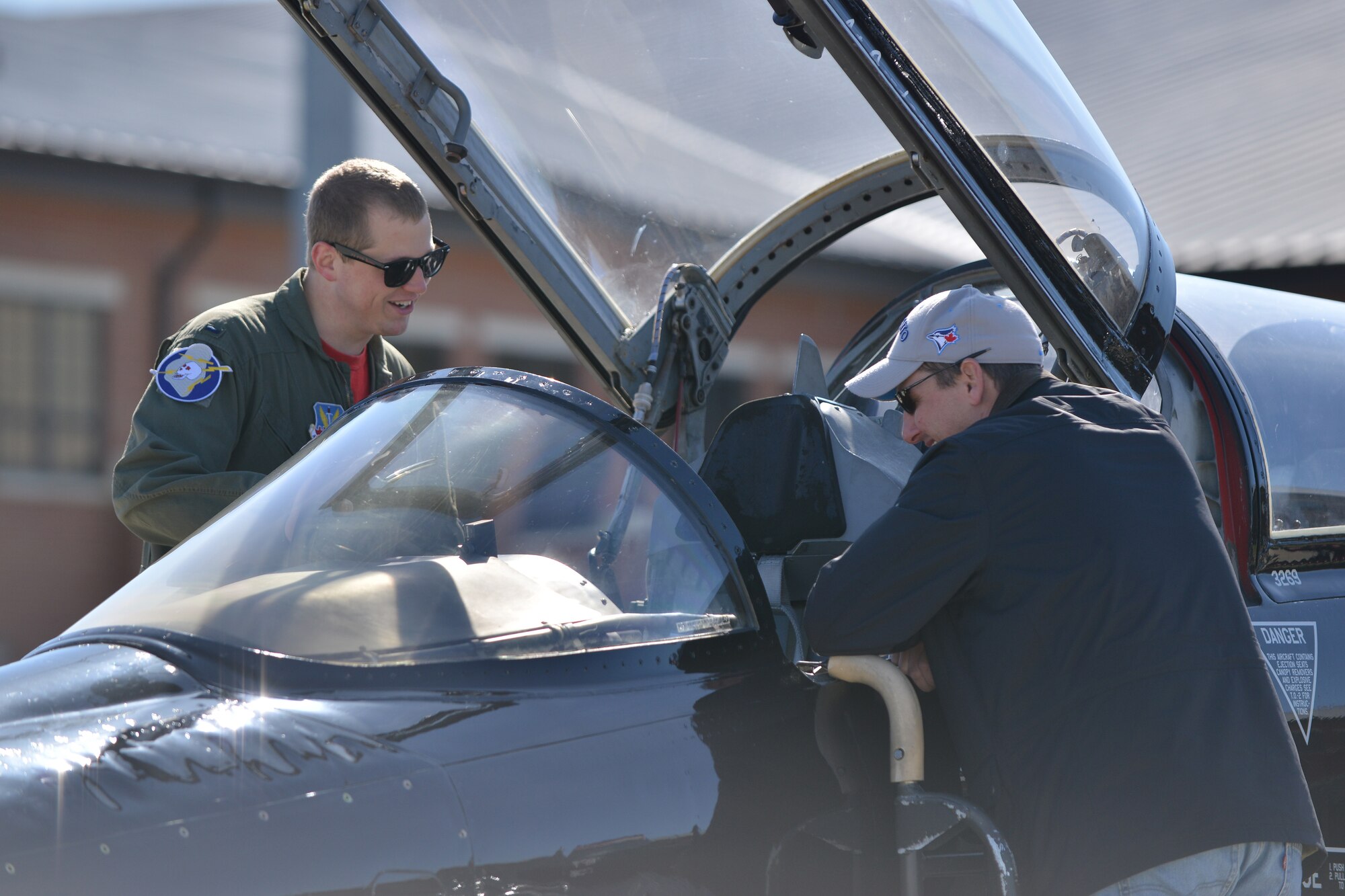 A U.S. Air Force T-38 Talon Pilot talks about the capabilities of the aircraft with an AirPower over Hampton Roads Open House attendee at Langley Air Force Base, Va., April 24, 2016.  The T-38 is often used as an aggressor in air-to-air training.  (U.S. Air Force photo by Staff Sgt. Natasha Stannard)