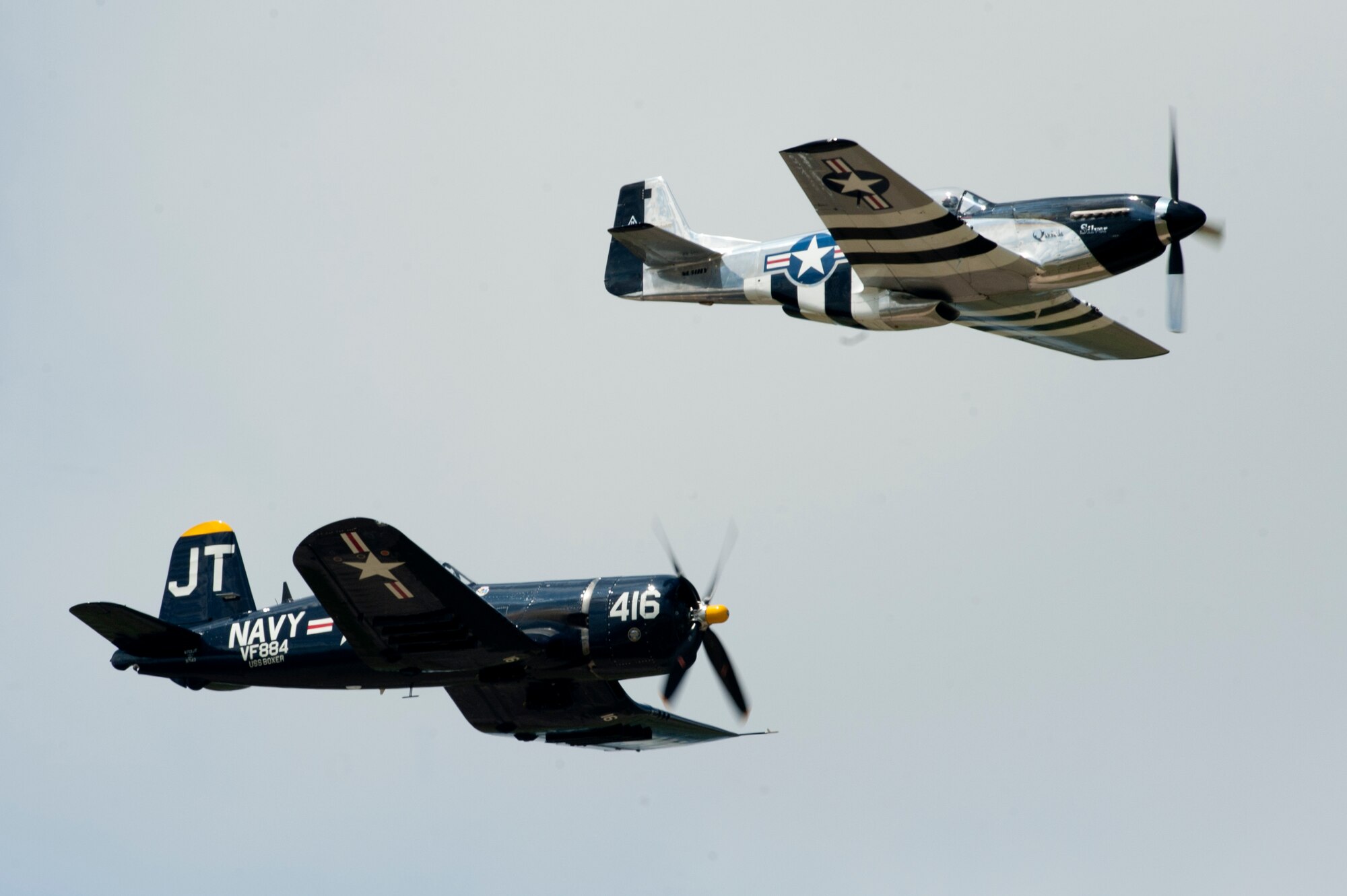 Jim Tobul, Corsair “Korean War Hero” pilot, flies with Scott Yoak, P-51 Mustang “Quicksilver pilot, during the AirPower over Hampton Roads Open House at Langley Air Force Base, Va., April 23, 2016. The pair flew in formation as a tribute to U.S. Service members who lost their throughout the world. (U.S. Air Force photo by Senior Airman R. Alex Durbin)