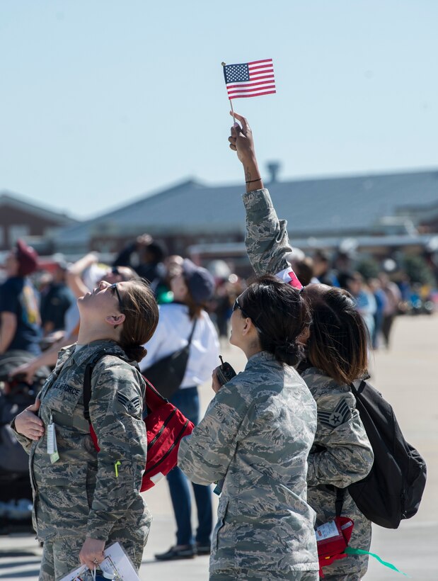 U.S. Airmen watch as the Golden Knights parachute team perform during the AirPower over Hampton Roads Open House at Langley Air Force Base, Va., April 24, 2016. The Golden Knights are one of three Department of Defense-sanctioned aerial demonstration teams, along with the U.S. Navy Blue Angels and the U.S. Air Force Thunderbirds. (U.S. Air Force photo by Senior Airman Kayla Newman)