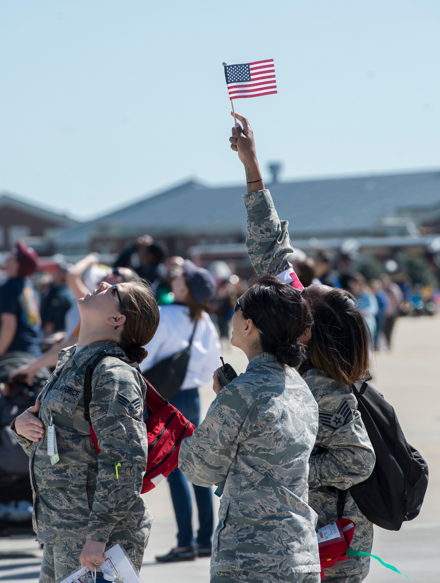 U.S. Airmen watch as the Golden Knights parachute team perform during the AirPower over Hampton Roads Open House at Langley Air Force Base, Va., April 24, 2016. The Golden Knights are one of three Department of Defense-sanctioned aerial demonstration teams, along with the U.S. Navy Blue Angels and the U.S. Air Force Thunderbirds. (U.S. Air Force photo by Senior Airman Kayla Newman)