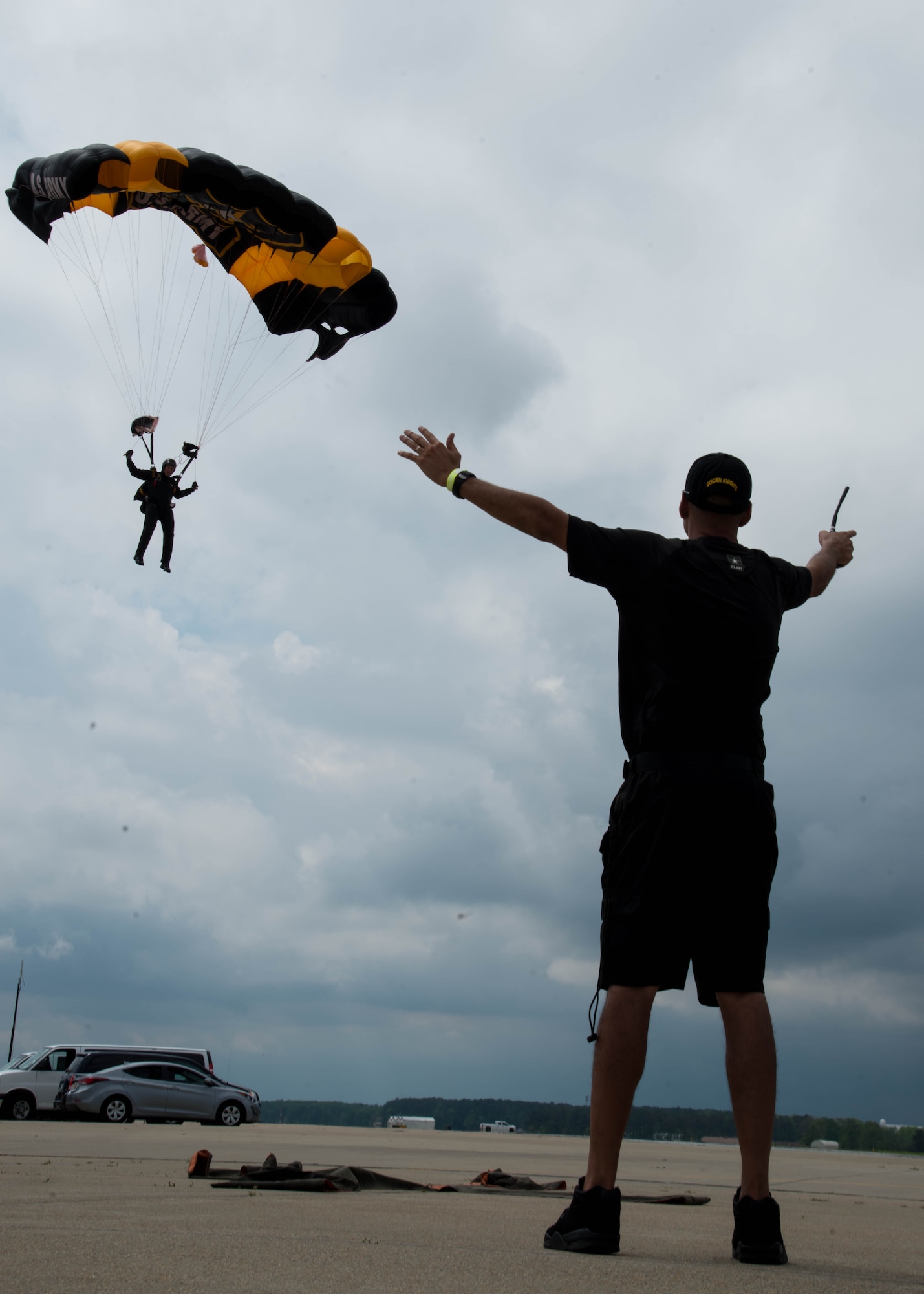 U.S. Army Master Sgt. Chris Parker, an aviation operator assigned to U.S. Army Golden Knights parachute team, marks the landing zone for a member of the Golden Knights during the Airpower Over Hampton Roads Open House at Langley Air Force Base, Va., April 24, 2016. The Golden Knights are one three Department of Defense-sanctioned aerial demonstration teams, along with the U.S. Navy Blue Angels and the U.S. Air Force Thunderbirds. (U.S. Air Force Photo by Staff Sgt. J.D. Strong II)