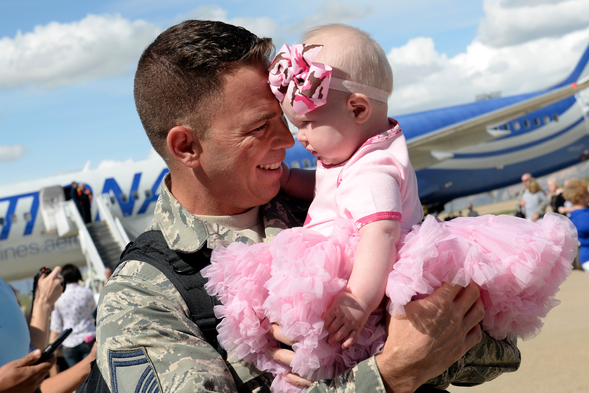 Senior Master Sgt. Dennis Dyke, 729th Air Control Squadron, greets his daughter Annabelle, seven months, upon his arrival April 24 at Hill Air Base, Utah. Dyke, who left for deployment in October 2015 when Annabelle was two weeks old, communicated with his family via Skype while away. The squadron’s key spouses were critical in communicating with family members of deployed Airmen, making the separation easier.  (U.S. Air Force photo by Paul Holcomb)