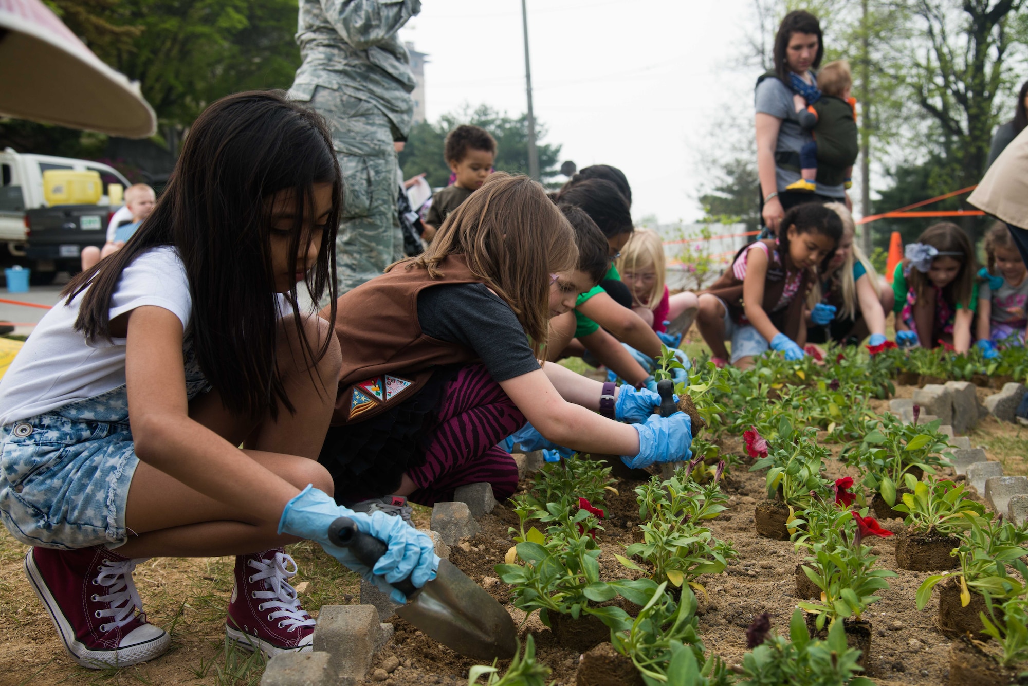 Team Osan children shovel dirt during an Arbor Day tree planting ceremony April 22, 2016, at Osan Air Base, Republic of Korea. Osan celebrates this observance annually with a commemorative tree planting ceremony which children help plant the trees on base.
(U.S. Air Force photo by Senior Airman Dillian Bamman/Released)
