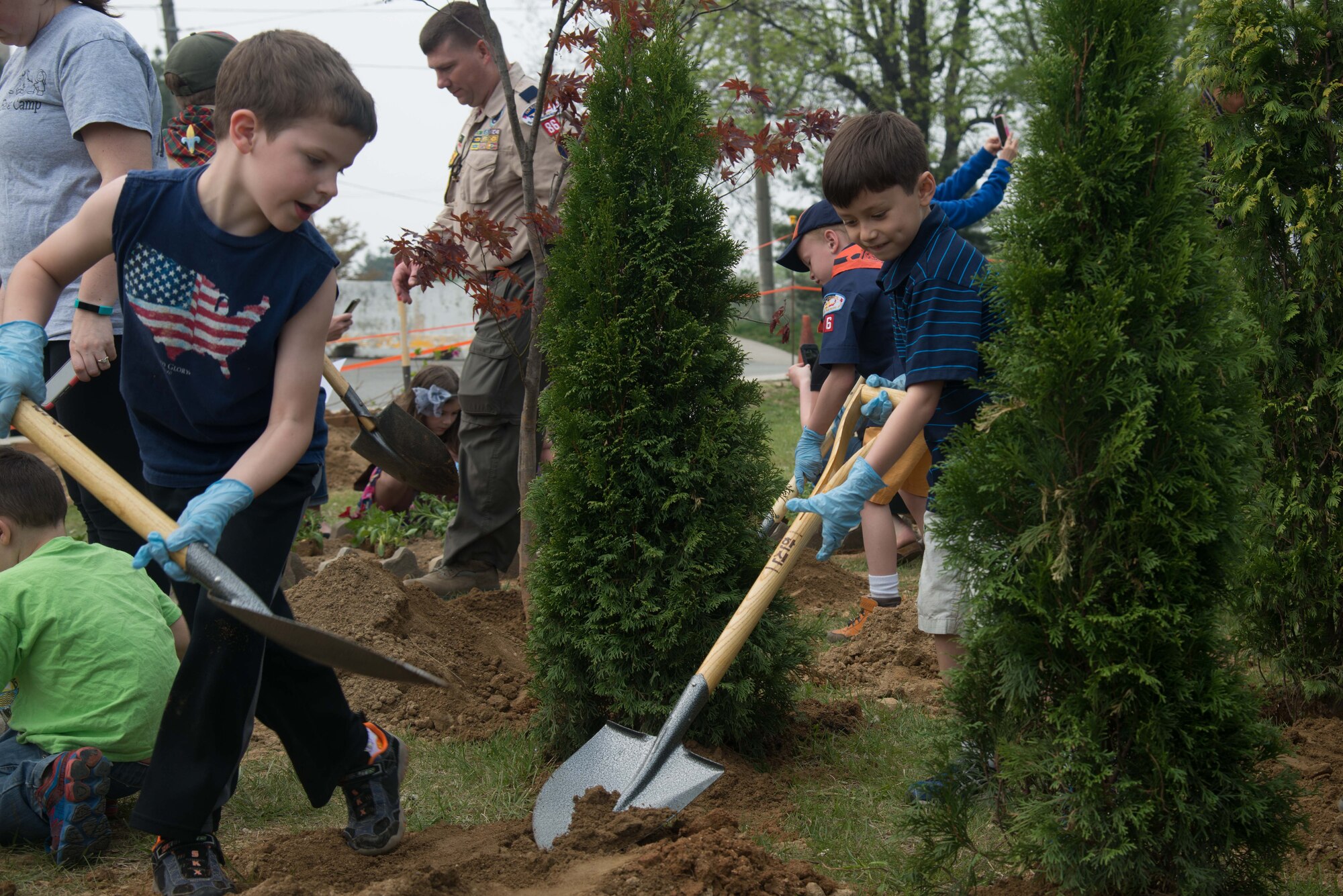 Team Osan children pot plants during an Arbor Day tree planting ceremony April 22, 2016, at Osan Air Base, Republic of Korea. Osan celebrates this observance annually with a commemorative tree planting ceremony which children help plant the trees on base. (U.S. Air Force photo by Senior Airman Dillian Bamman/Released)