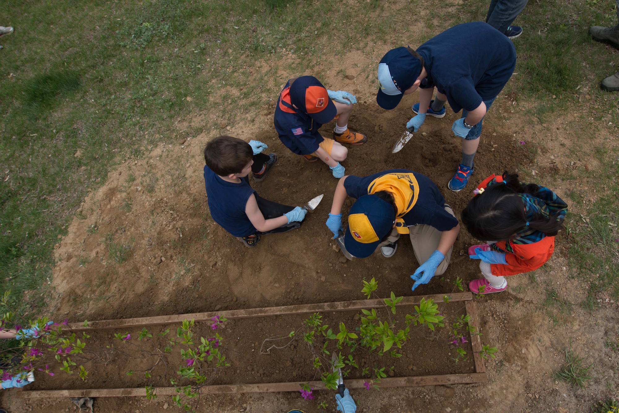 Team Osan children pot plants during an Arbor Day tree planting ceremony April 22, 2016, at Osan Air Base, Republic of Korea. Osan celebrates this observance annually with a commemorative tree planting ceremony which children help plant the trees on base. (U.S. Air Force photo by Senior Airman Dillian Bamman/Released)