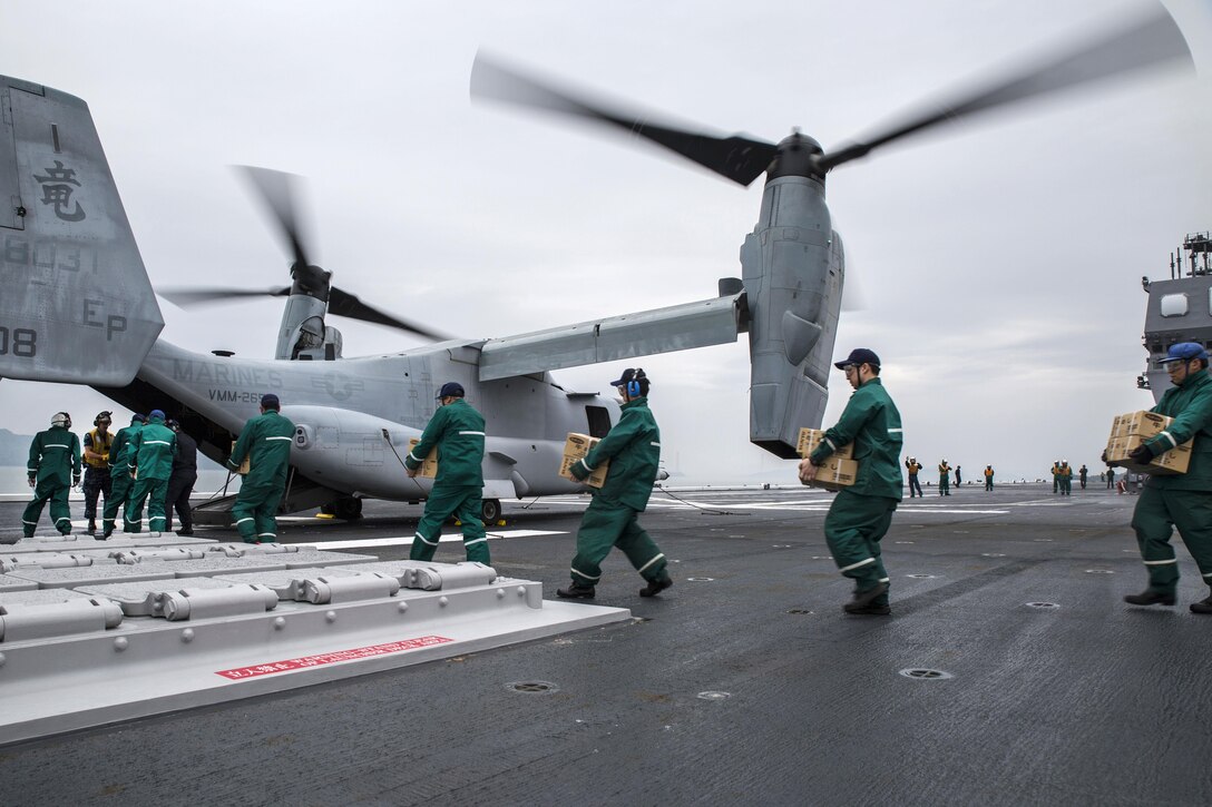 Japan Maritime Self Defense Force personnel, U.S. sailors and U.S. Marines load supplies onto a U.S. Marine Corps MV-22B Osprey aircraft aboard the JS Hyuga at sea, near Kumamoto, Japan, April 23, 2016. The Marines and aircraft are assigned to Marine Medium Tiltrotor Squadron 265, 31st Marine Expeditionary Unit. The humanitarian aid is part of the relief effort after a series of earthquakes struck the island of Kyushu. Marine Corps photo by Cpl. Nicole Zurbrugg