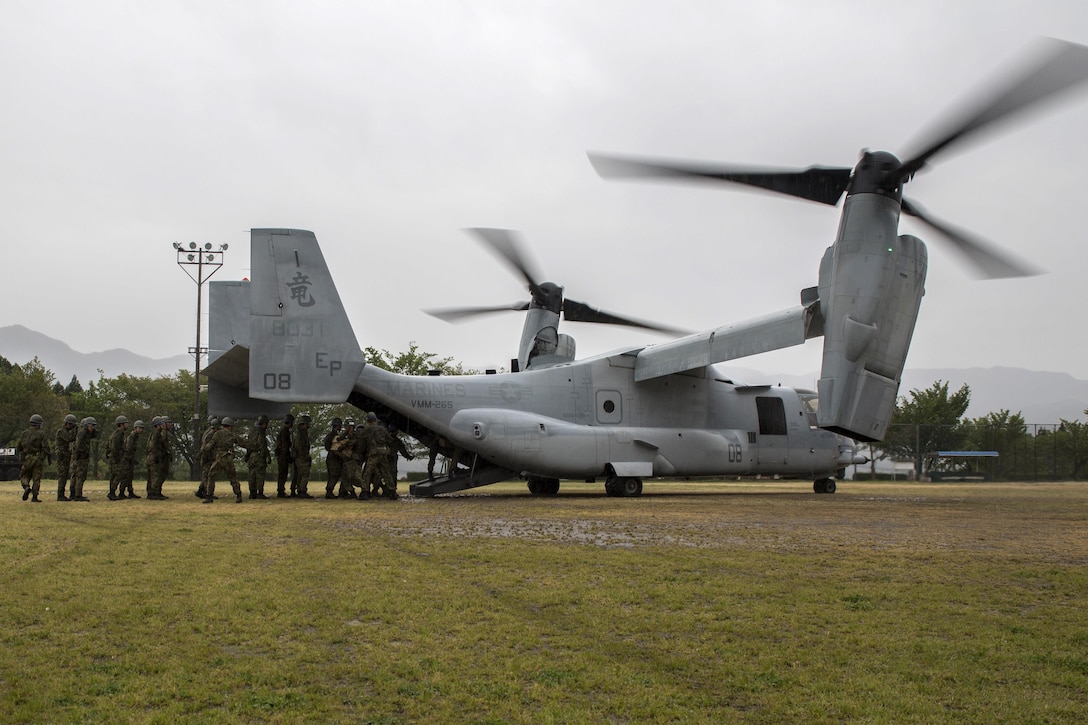 Japanese soldiers carry supplies from a U.S. Marine Corps MV-22B Osprey aircraft at the Hakusui Sports Park, Kyushu Island, Japan, April 23, 2016. Marine Corps photo by Cpl. Nicole Zurbrugg