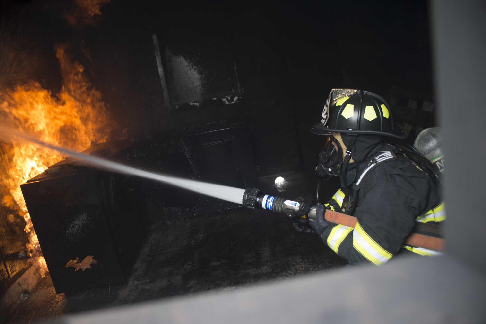 Airmen with the 512th Airlift Wing train fire-fighting skills as they extinguish a structure fire at Dover Air Force Base, Del., April 23, 2016. This training occurs twice a year to keep the fire fighters current and proficient in their training requirements. (U.S. Air Force photo by Tech. Sgt. Nathan Rivard)