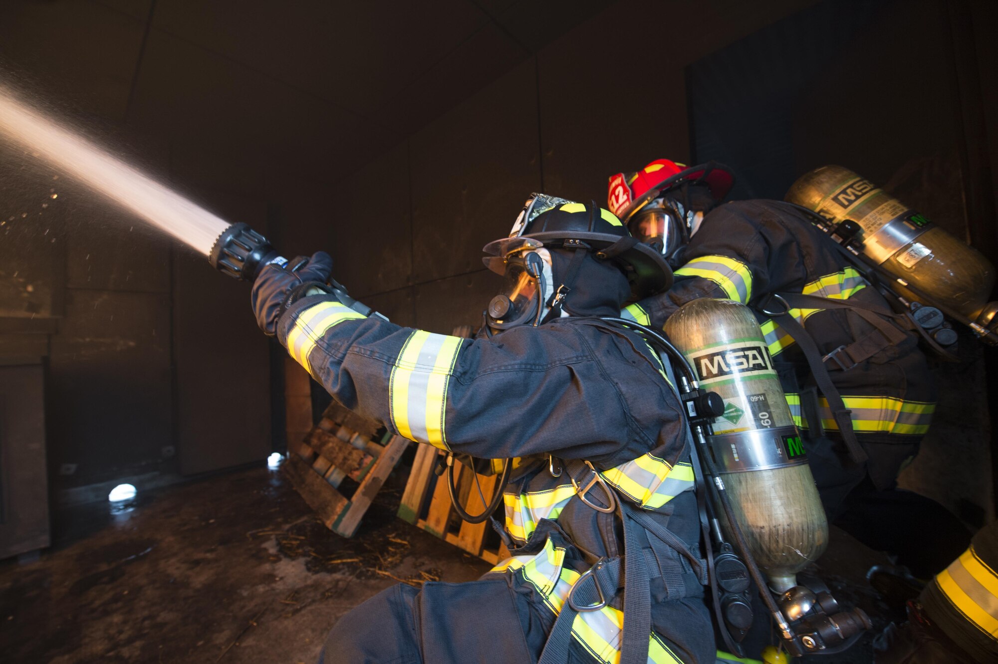 Airmen with the 512th Airlift Wing train fire-fighting skills as they extinguish a structure fire at Dover Air Force Base, Del., April 23, 2016. This training occurs twice a year to keep the fire fighters current and proficient in their training requirements. (U.S. Air Force photo by Tech. Sgt. Nathan Rivard)