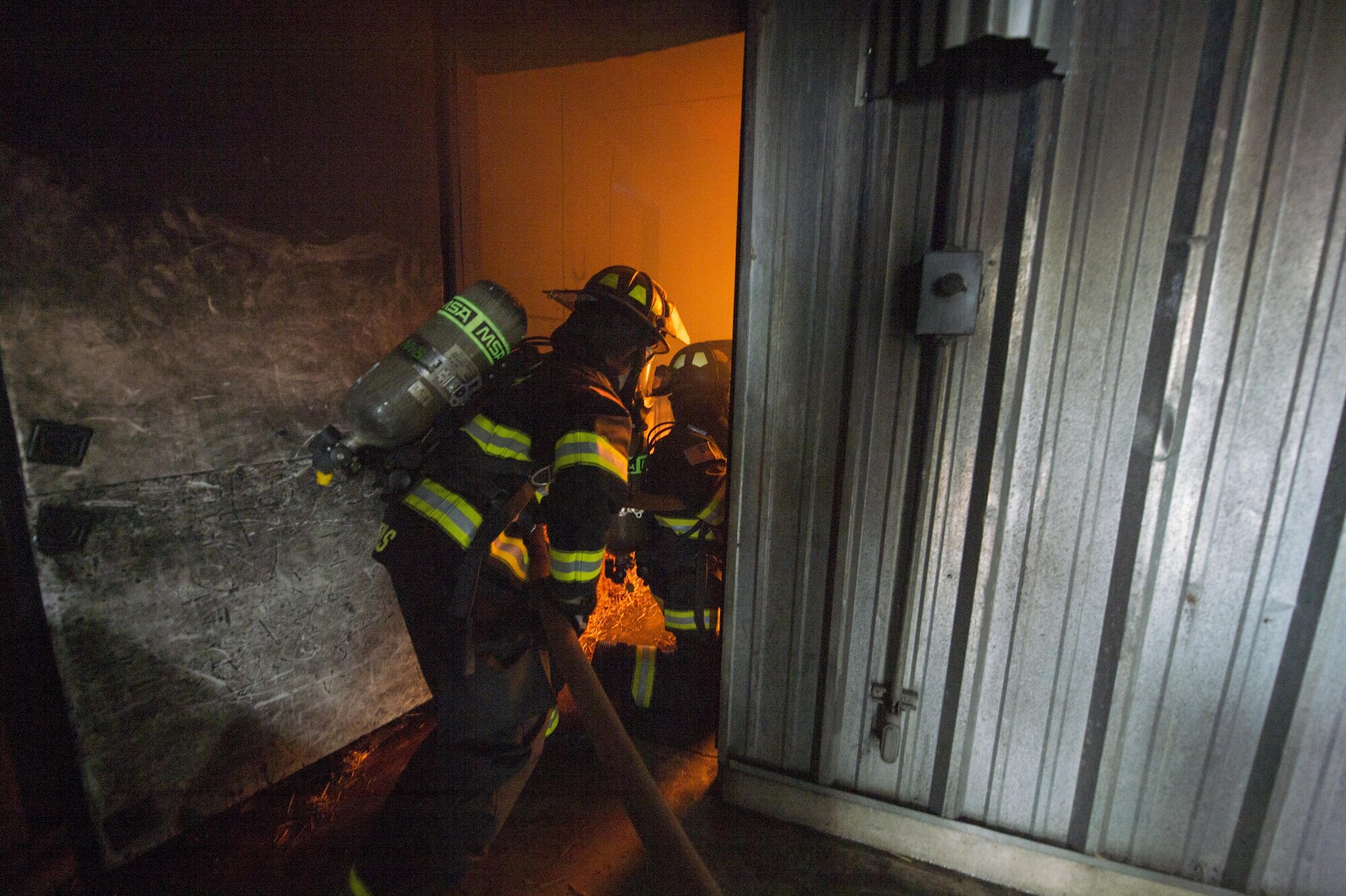 Airmen with the 512th Airlift Wing train fire-fighting skills as they extinguish a structure fire at Dover Air Force Base, Del., April 23, 2016. This training occurs twice a year to keep the fire fighters current and proficient in their training requirements. (U.S. Air Force photo by Tech. Sgt. Nathan Rivard)