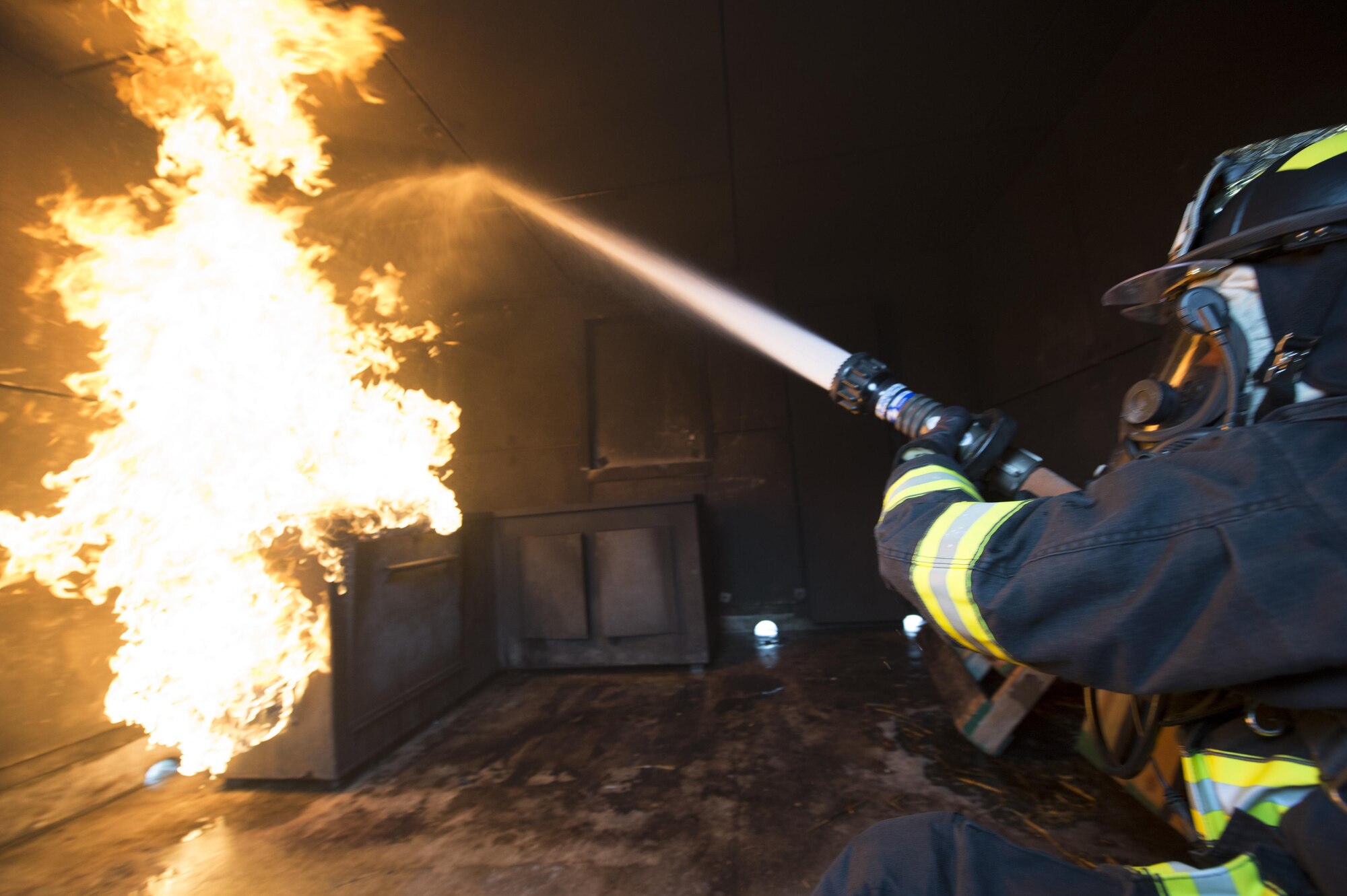 Airmen with the 512th Airlift Wing train fire-fighting skills as they extinguish a structure fire at Dover Air Force Base, Del., April 23, 2016. This training occurs twice a year to keep the fire fighters current and proficient in their training requirements. (U.S. Air Force photo by Tech. Sgt. Nathan Rivard)