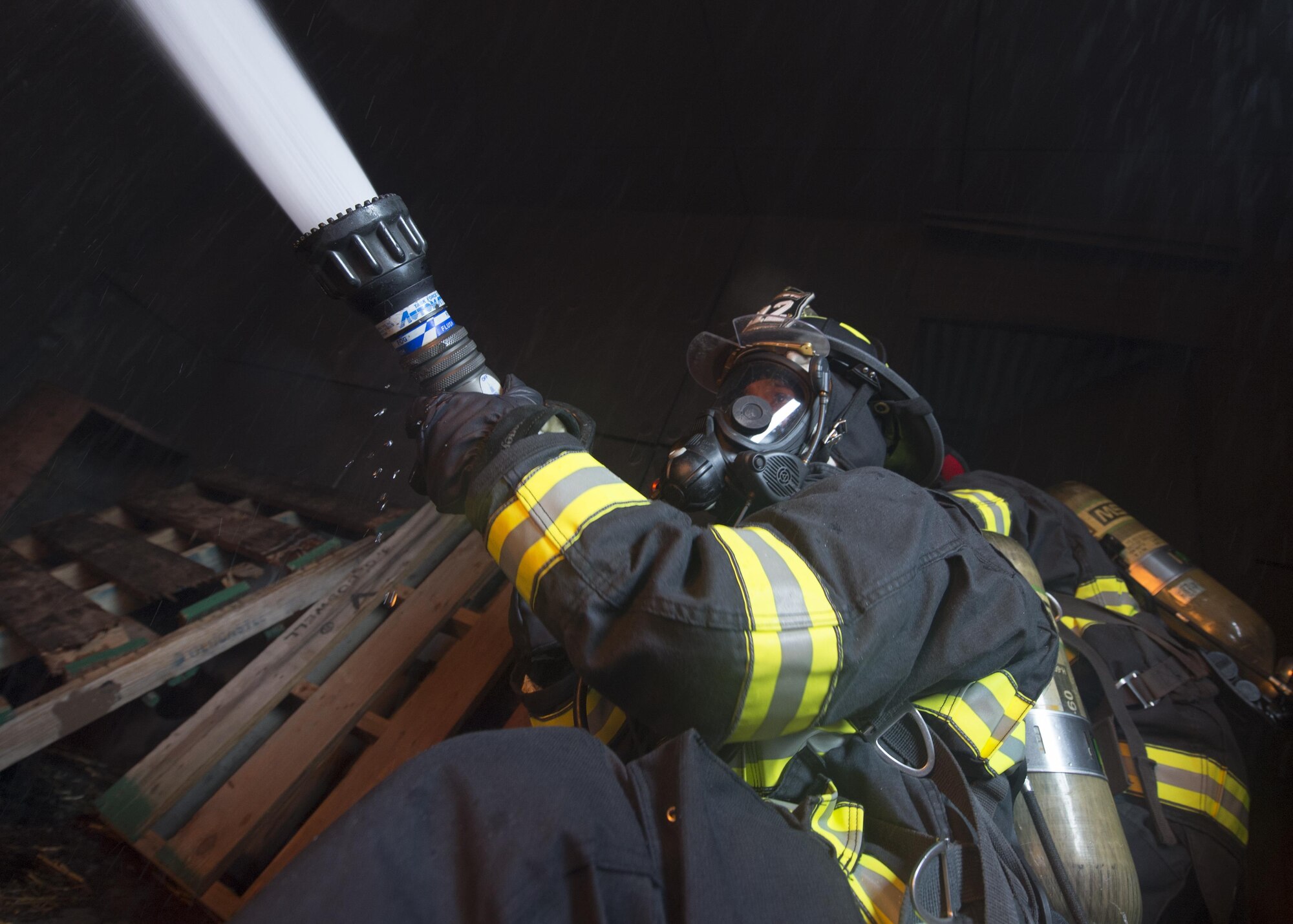 Airmen with the 512th Airlift Wing train fire-fighting skills as they extinguish a structure fire at Dover Air Force Base, Del., April 23, 2016. This training occurs twice a year to keep the fire fighters current and proficient in their training requirements. (U.S. Air Force photo by Tech. Sgt. Nathan Rivard)