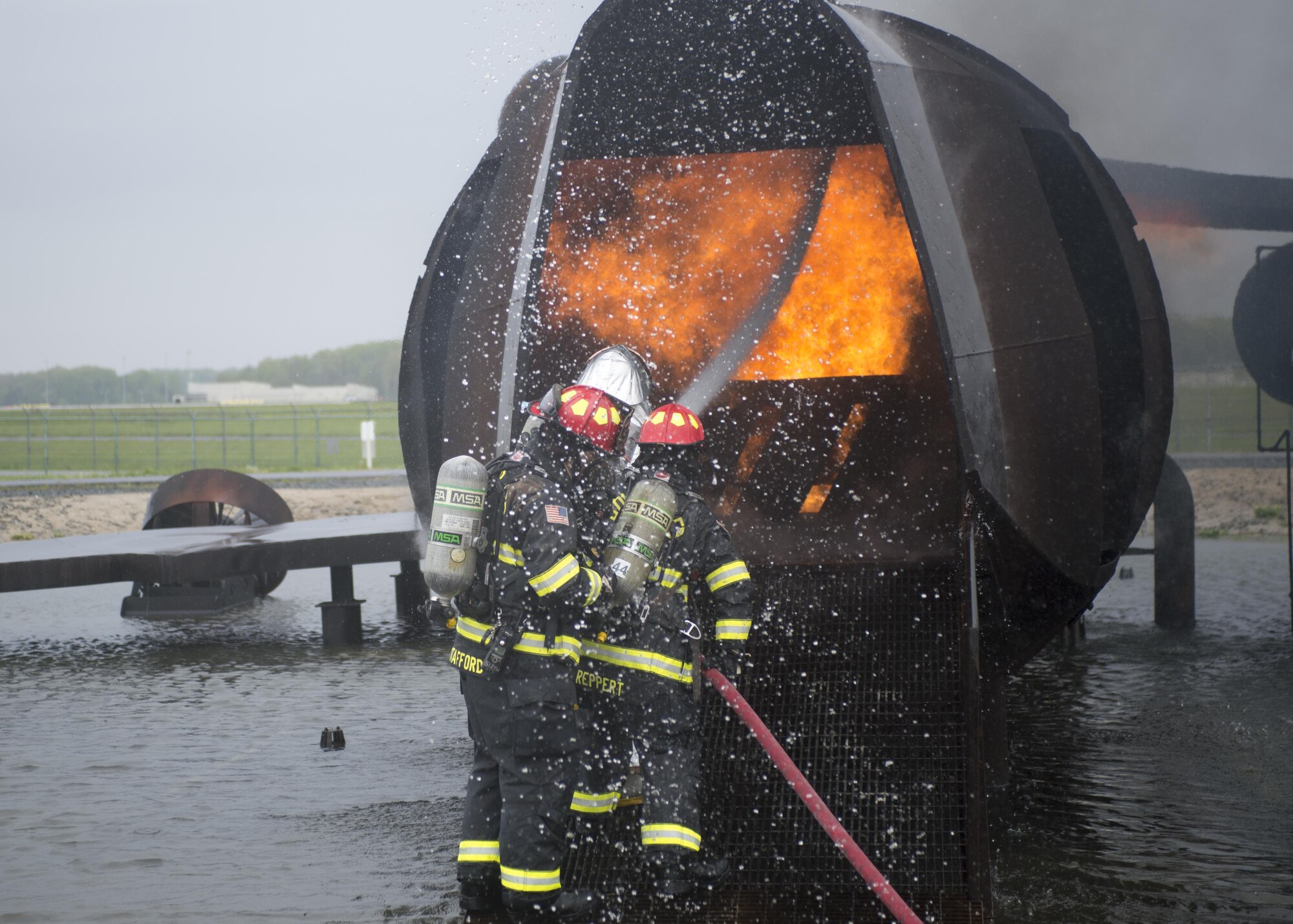 Airmen with the 512th Airlift Wing train fire-fighting skills as they extinguish an aircraft fire at Dover Air Force Base, Del., April 23, 2016. This training occurs twice a year to keep the fire fighters current and proficient in their training requirements. (U.S. Air Force photo by Tech. Sgt. Nathan Rivard)