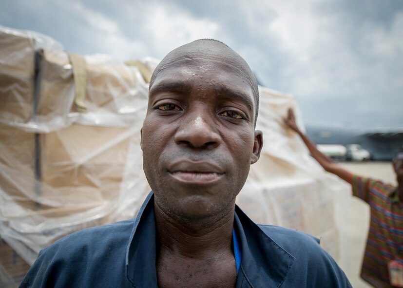 A man unloads pallets of food April 21, 2016, in Port-au-Prince, Haiti, during a Denton Cargo mission involving the 701st Airlift Squadron. Two C-17 Globemaster IIIs, filled with thirty-two combined pallets and delivered more than 100 thousand total pounds of humanitarian aid to Haiti. Since 1998, The Denton Program has overseen more than 5 million pounds of humanitarian supplies have been sent to more than 50 countries across the globe.  (U.S. Air Force photo by Senior Airman Tom Brading)