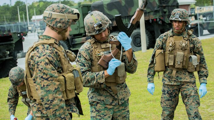 Marines zip-tie a weapon found during a search to prevent the weapon from misfiring during the Tactical Site Exploitation Course, taught by 2nd Law Enforcement Battalion, at Marine Corps Base Camp Lejeune, N.C., April 20, 2016. The site exploitation course is a week long course that trains Marines how to remove and safely store evidence such as cigarette butts, computers and improvised explosive devices. 