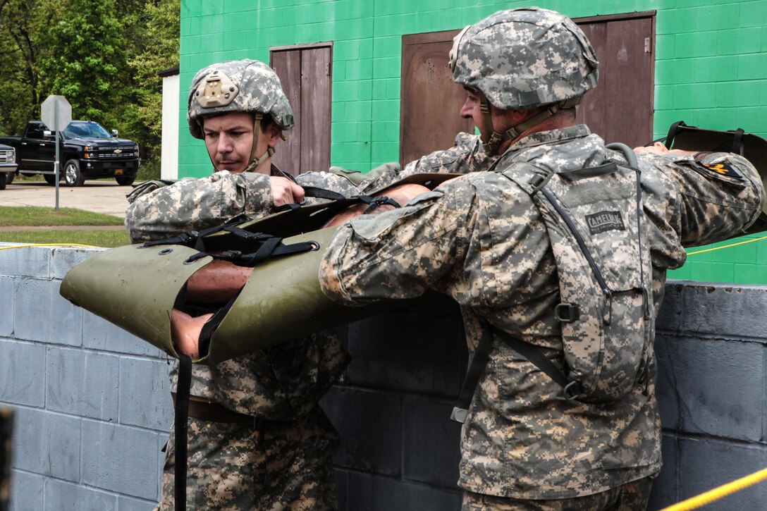 Army Sgt. 1st Class William Causey, left, and Army Sgt. 1st Class Roger Richardson transport a mannequin on a stretcher during the Best Ranger Competition at Fort Benning, Ga., April 15, 2016. Causey and Richardson are assigned to the U.S. Army John F. Kennedy Special Warfare Center and School. Army photo by Spc. Terrell Maxwell