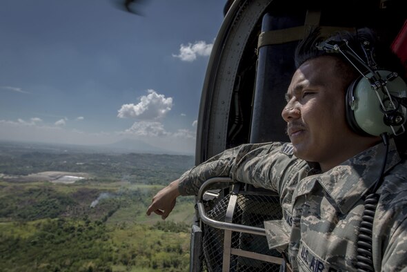Staff Sgt. Jay Perocho Acasio, an aircrew flight equipment journeyman with the 51st Operations Support Squadron at Osan Air Base, South Korea, looks out over his home country during a HH-60G Pave Hawk flight near Clark Air Base, Philippines, April 22, 2016. Acasio is one of three Filipino-American Airmen serving U.S. Pacific Command’s air contingent in the Philippines. Acasio is from Ozamiz City in the Misamis Occidental, Philippines. (U.S. Air Force photo/Staff Sgt. Benjamin W. Stratton)