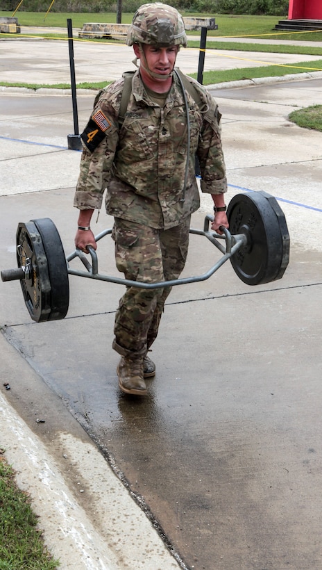 Army First Sgt. Edward Crosby completes the farmer's carry obstacle  during the Best Ranger Competition at Fort Benning, Ga., April 15, 2016. Crosby is assigned to the 3rd Infantry Division.  Army photo by Spc. Terrell Maxwell 
