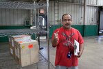 Amaury Rodriguez, DLA Distribution Warner Robins, prepares a “red hot” C-130 package for pick up.  
