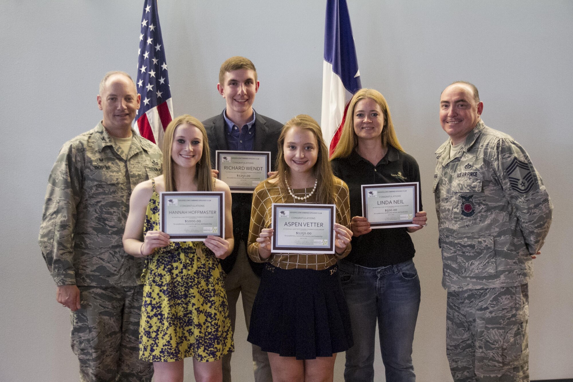 U.S. Air Force Col. Michael L. Downs, 17th Training Wing Commander, and Chief Master Sgt. Jesus Longoria Jr., 312th Training Squadron superintendent, present awardees: Hannah Hoffmaster, Central High School; Richard Wendt, Central High School; Apsen Vetter, Central High School; and Linda Neil, during the Goodfellow Combined Spouses Club dinner at the Event Center on Goodfellow Air Force Base, Texas, April 20, 2016. The mission of the Goodfellow Combined Spouses Club organization is to develop, organize, and sponsor educational, charitable and social activities in keeping with the ideals of the United States Military. (Courtesy photo used with permission) 