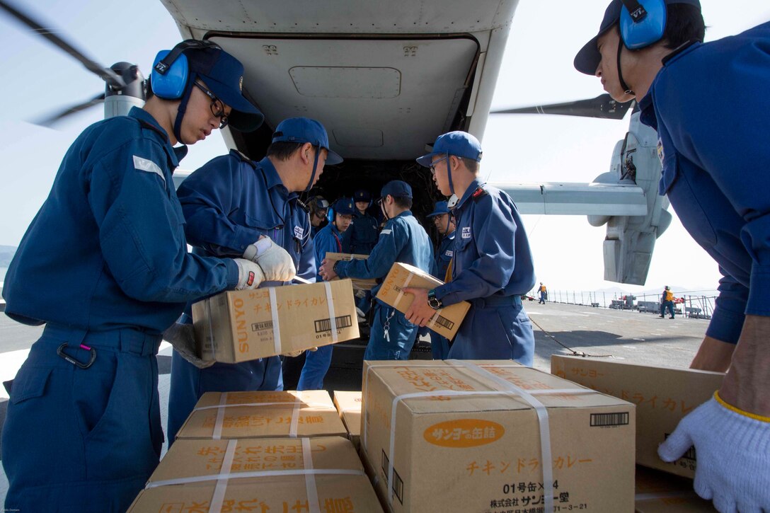 Japan Maritime Self Defense Force personnel, U.S. Navy sailors and U.S. Marines load supplies onto a U.S. Marine Corps MV-22B Osprey tiltrotor aircraft from Marine Medium Tiltrotor Squadron (VMM) 265 (Reinforced), 31st Marine Expeditionary Unit aboard the JS Hyuga, at sea, April 22, 2016. The supplies are in support of relief efforts after a series of earthquakes struck the island of Kyushu. The 31st MEU is the only continually forward-deployed MEU and remains the Marine Corps' force-in-readiness in the Asia-Pacific region. 