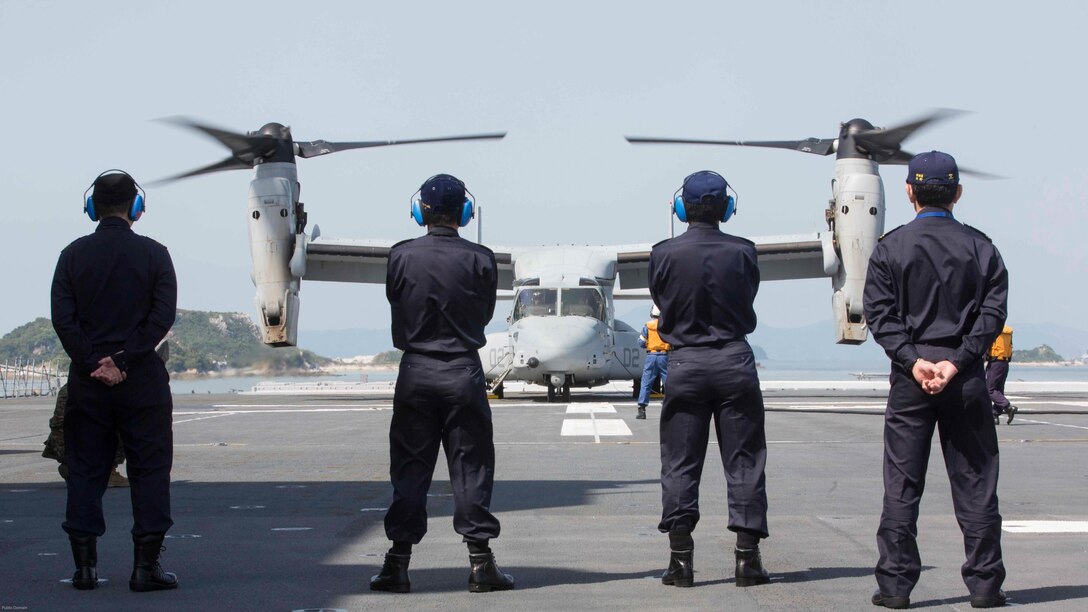 Japan Maritime Self Defense Force officers watch as a U.S. Marine Corps MV-22B Osprey tiltrotor aircraft from Marine Medium Tiltrotor Squadron (VMM) 265 (Reinforced), 31st Marine Expeditionary Unit, refuels aboard the JS Hyuga, at sea, April 22, 2016. The Osprey received supplies from the Hyuga in support of the relief effort after a series of earthquakes struck the island of Kyushu. The 31st MEU is the only continually forward-deployed MEU and remains the Marine Corps' force-in-readiness in the Asia-Pacific region. 
